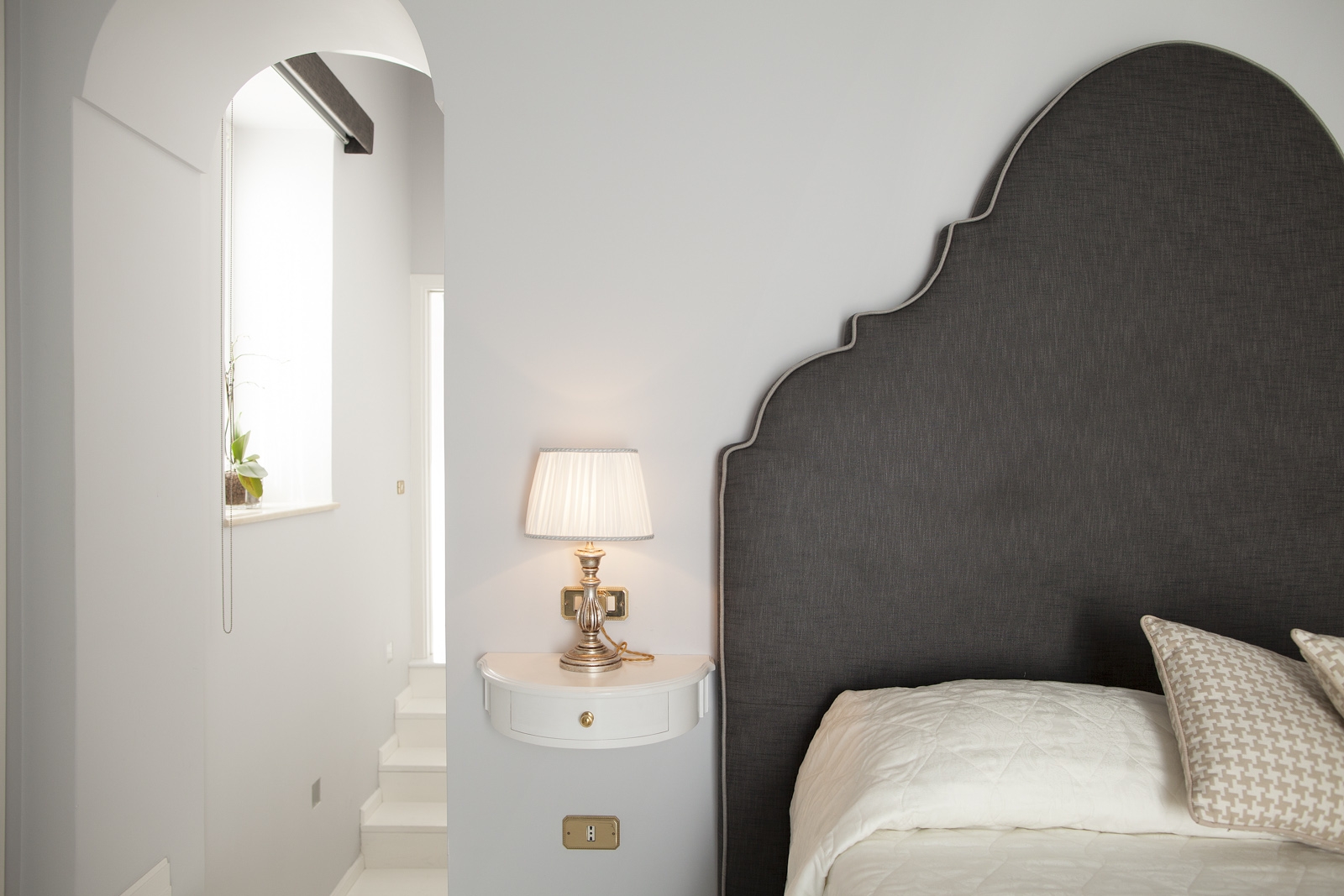 Bedroom with double bed, bedside table and lamp at Villa di Praiano on the Amalfi Coast in Italy