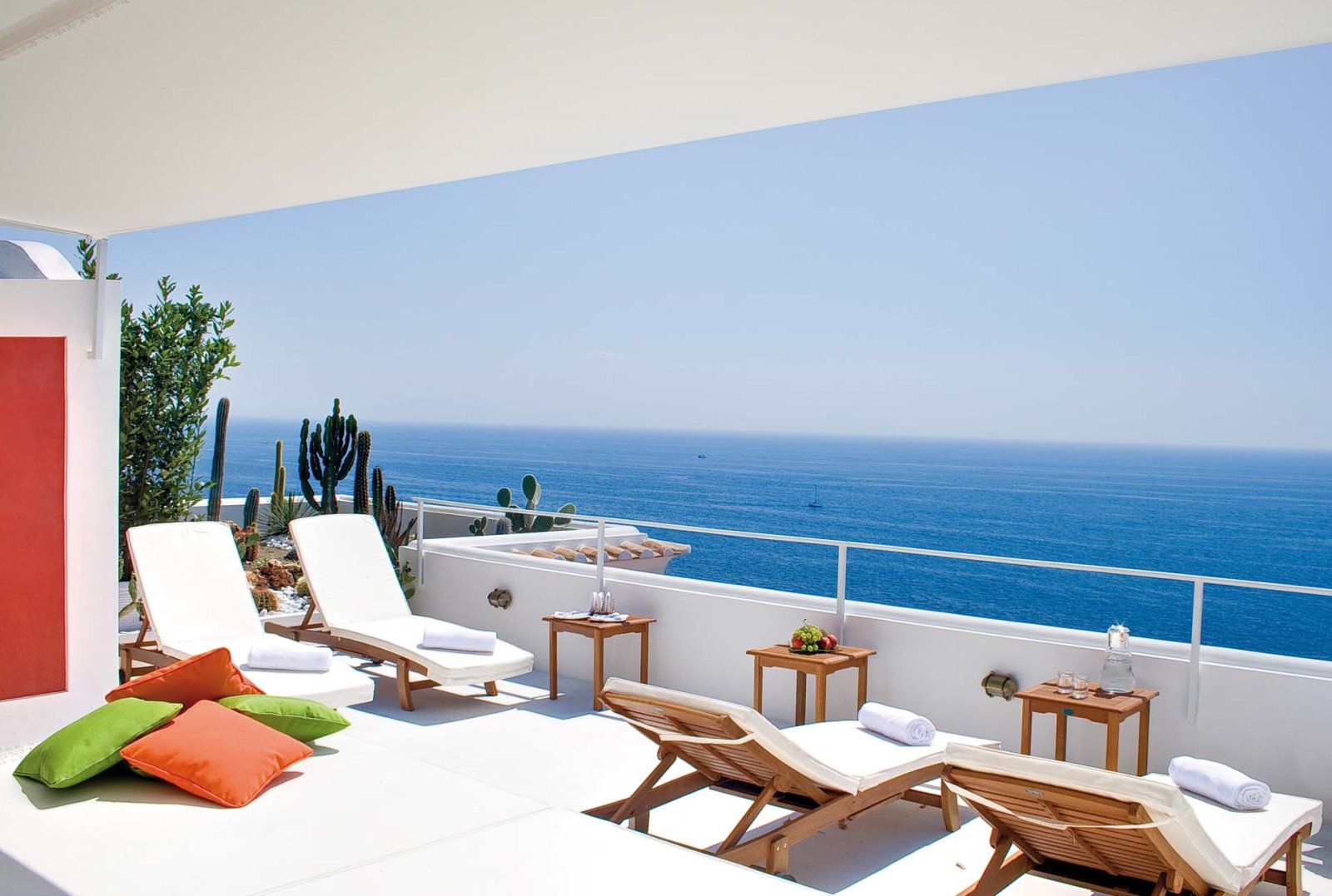 Balcony with sun loungers, tables, cacti and sea view at Villa di Praiano on the Amalfi Coast, Italy