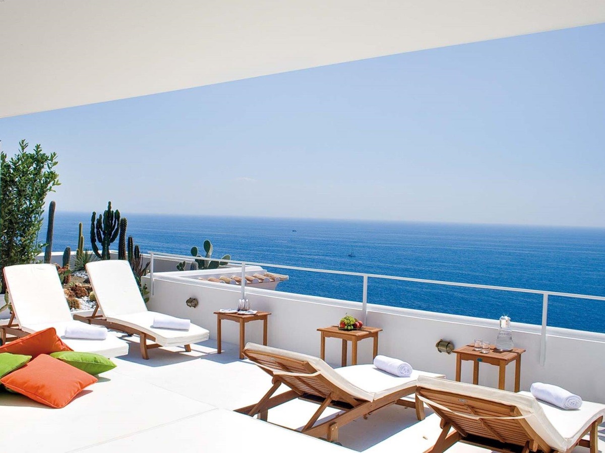 Balcony with sun loungers, tables, cacti and sea view at Villa di Praiano on the Amalfi Coast, Italy