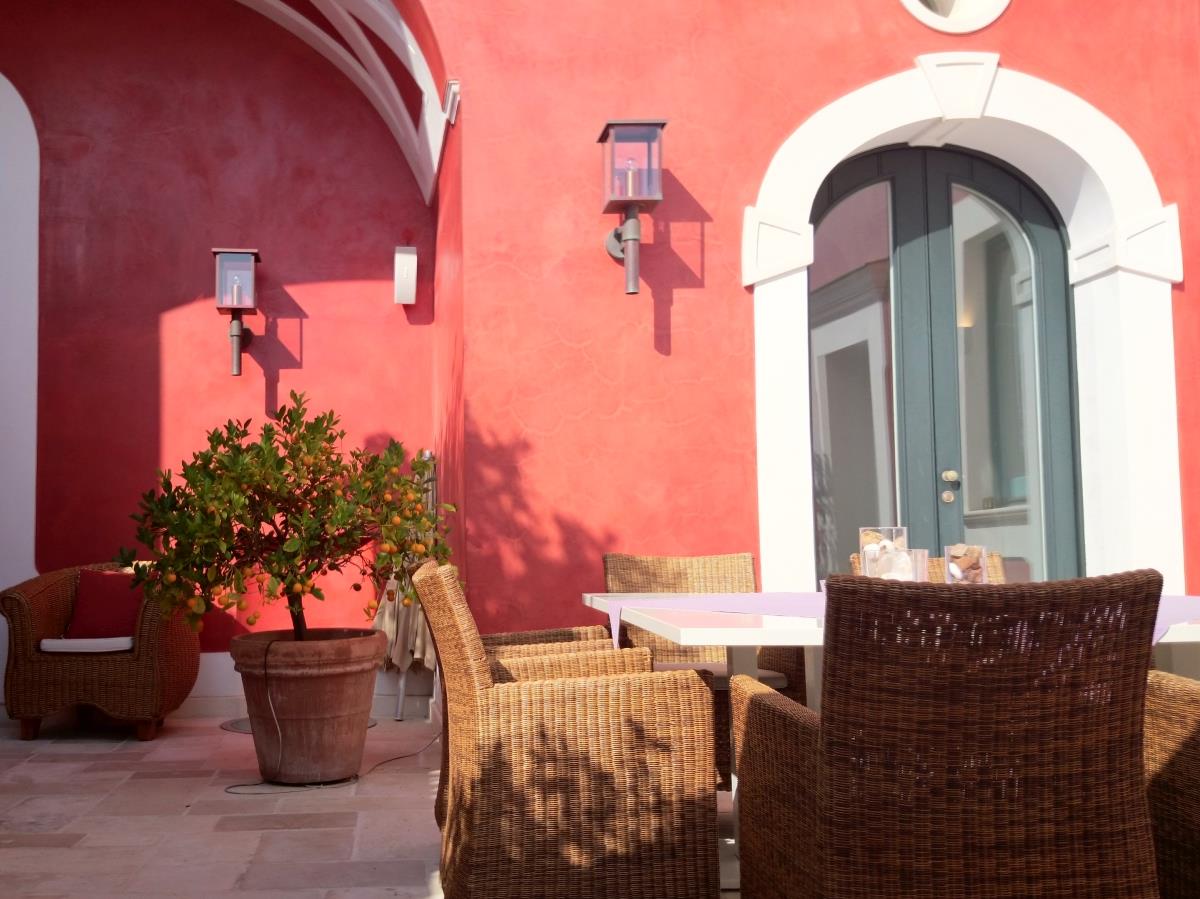 Terrace with table, comfy chairs and citrus tree at Villa di Praiano on the Amalfi Coast in Italy