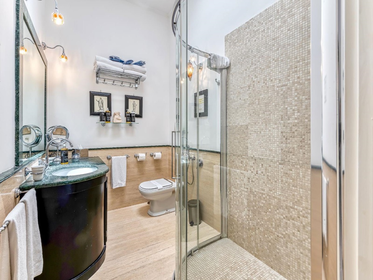Bathroom with tiled shower and basin area at Villa Li Galli in Amalfi