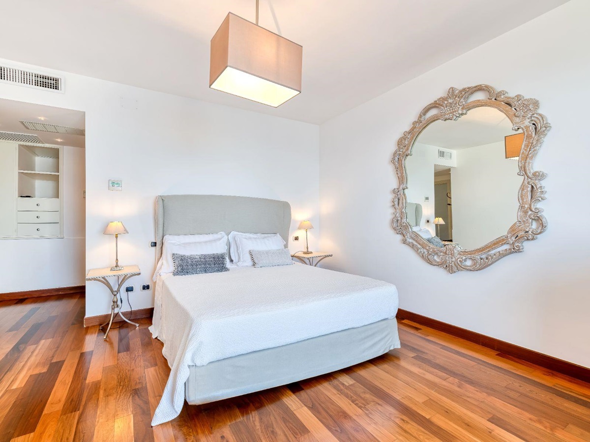 Bedroom double bed and large mirror on the wall in Villa Li Galli in Amalfi