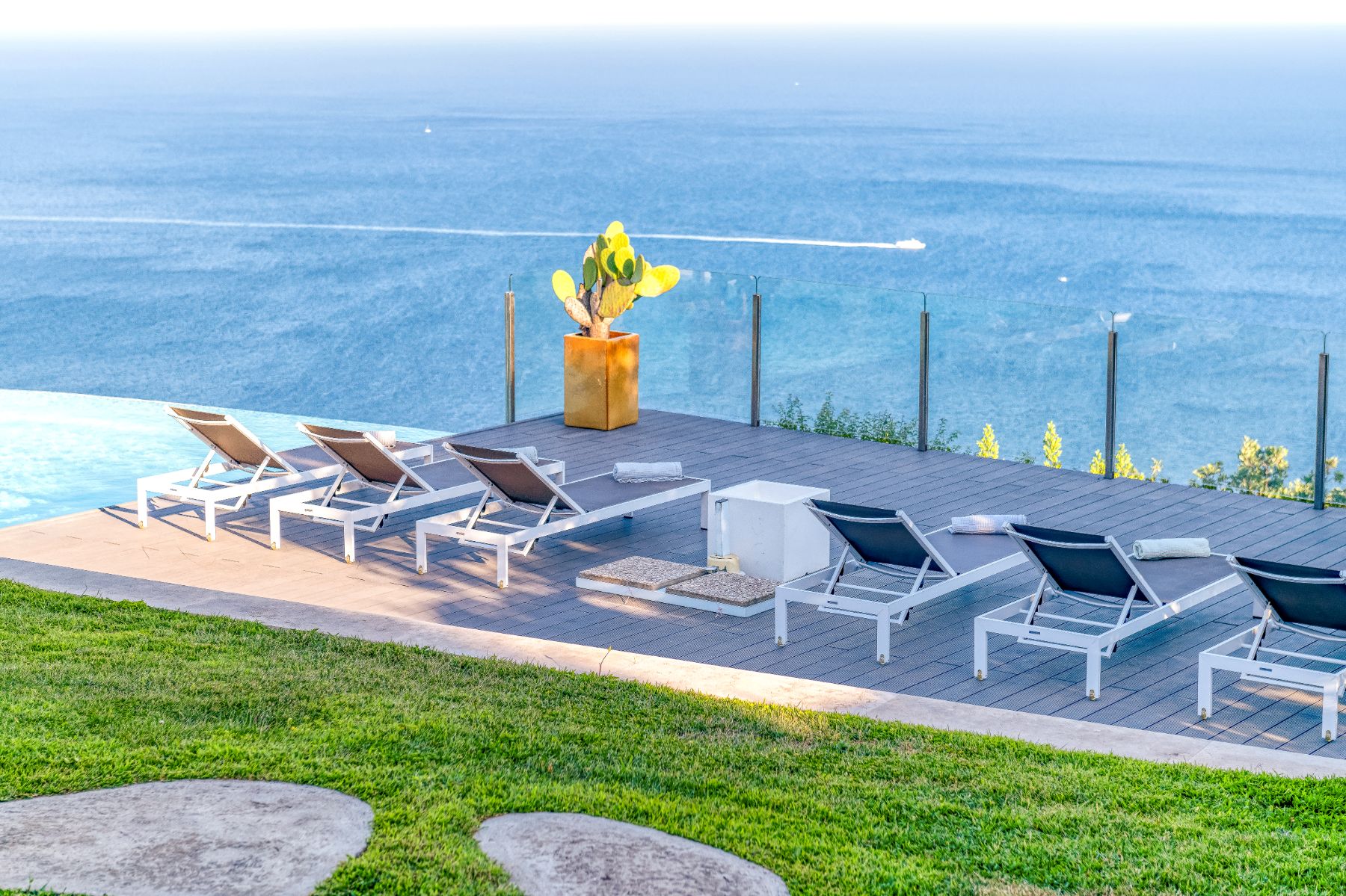 View of a row of deckchairs on the terrace overlooking the sea at Villa Li Galli in Amalfi
