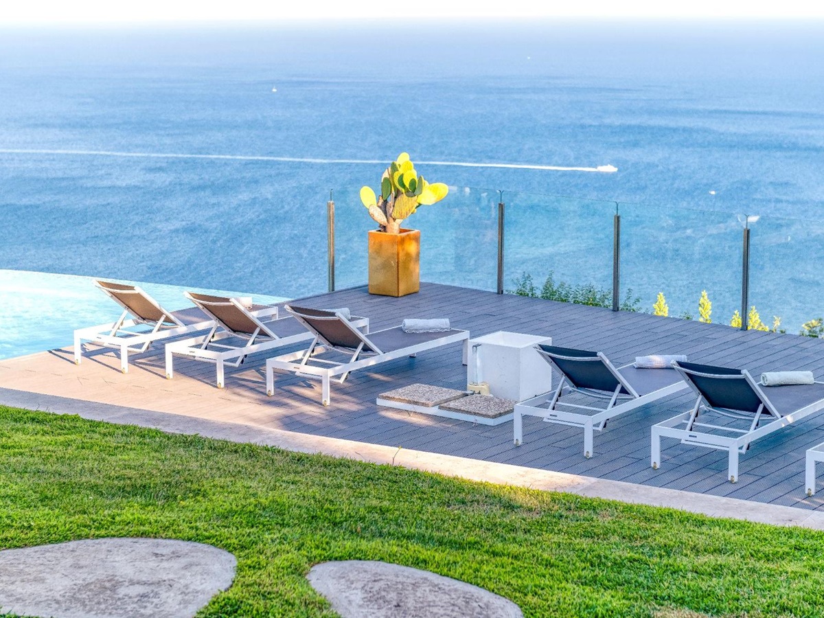 View of a row of deckchairs on the terrace overlooking the sea at Villa Li Galli in Amalfi