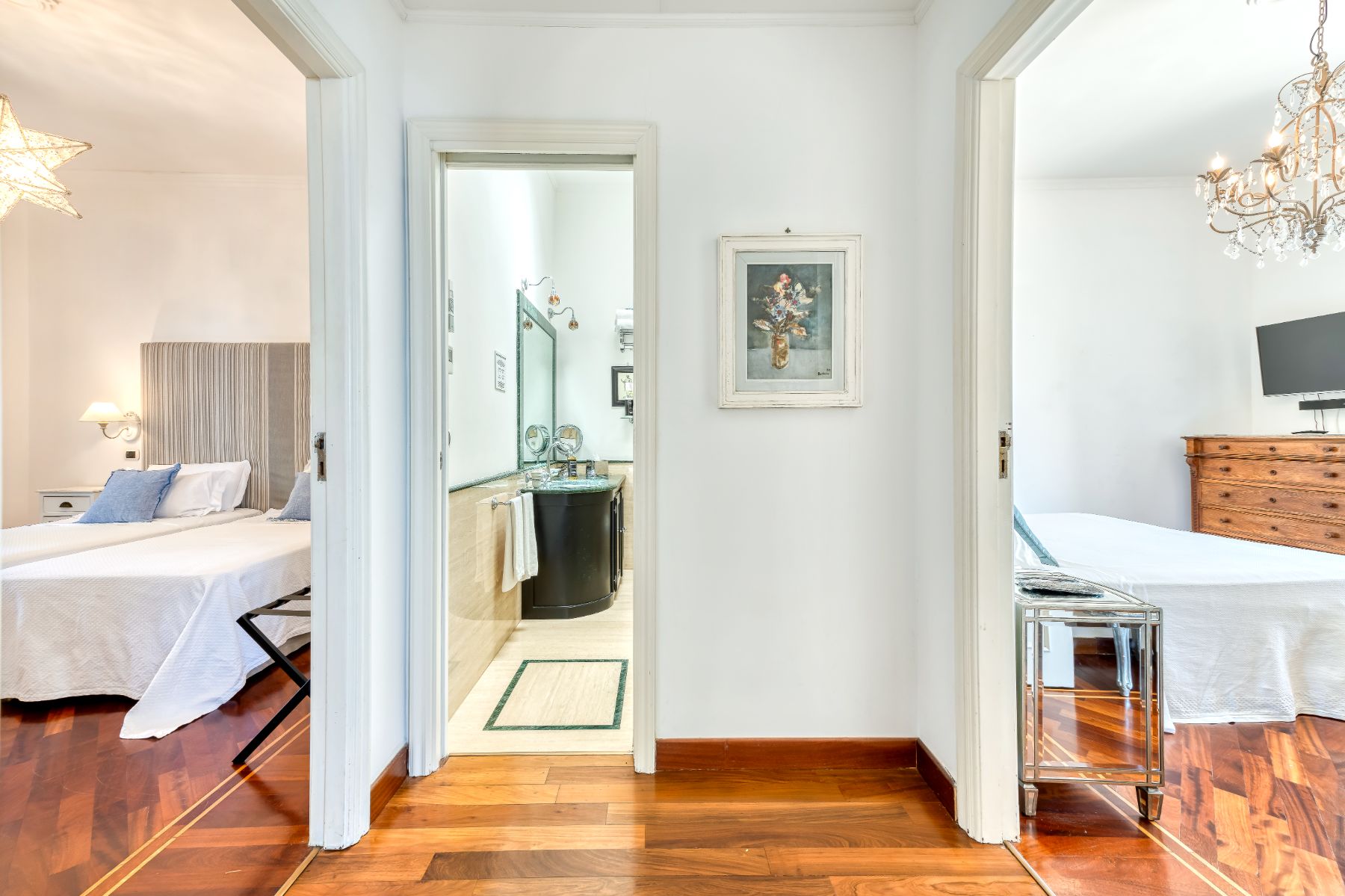Hallway area with view of the bathroom in the middle and a bedroom either side at Villa Li Galli in Amalfi