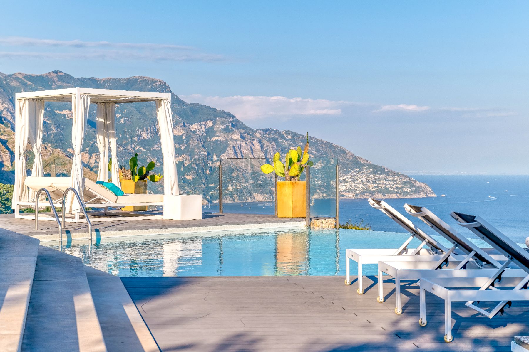 Terrace with the pool and sunbeds in view, overlooking the sea and coastline at Villa Li Galli in Amalfi