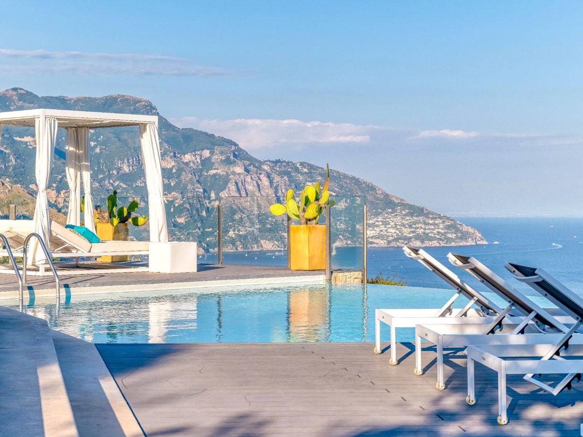 Terrace with the pool and sunbeds in view, overlooking the sea and coastline at Villa Li Galli in Amalfi