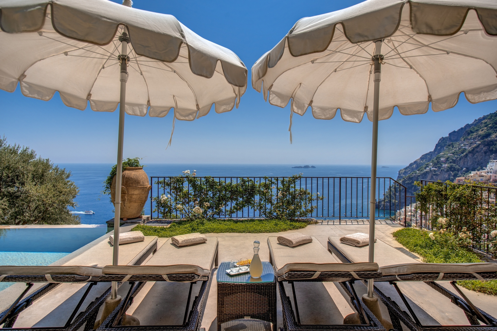 Two sun loungers on the terrace looking out towards the sea