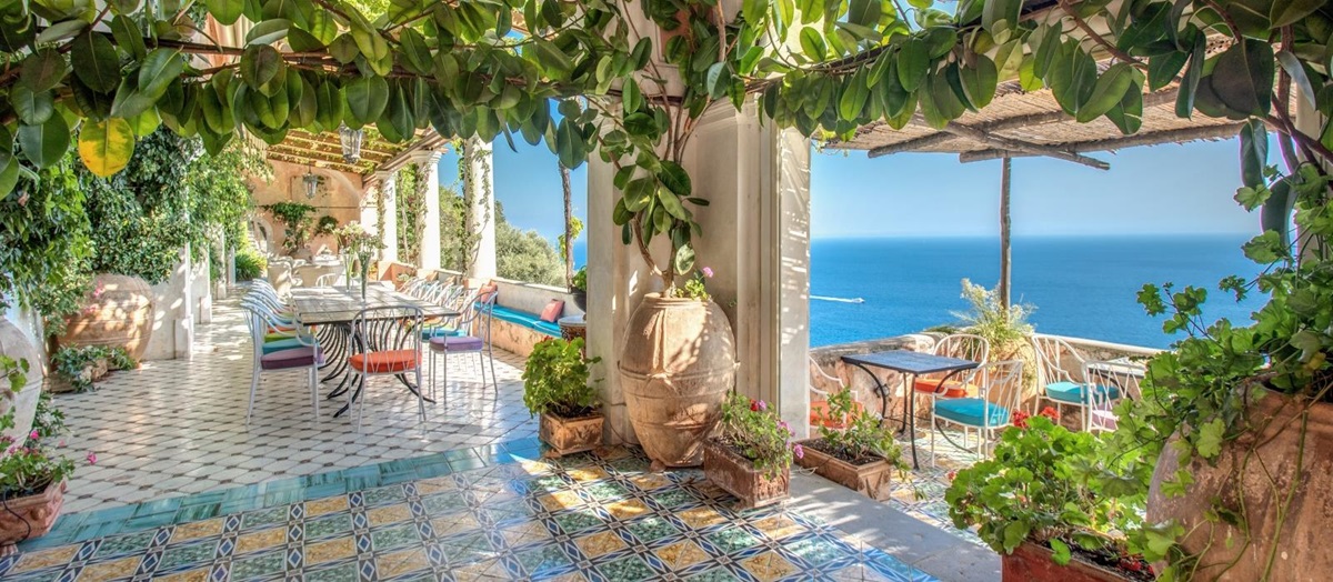 A shaded terrace with colourful blue tiled floor