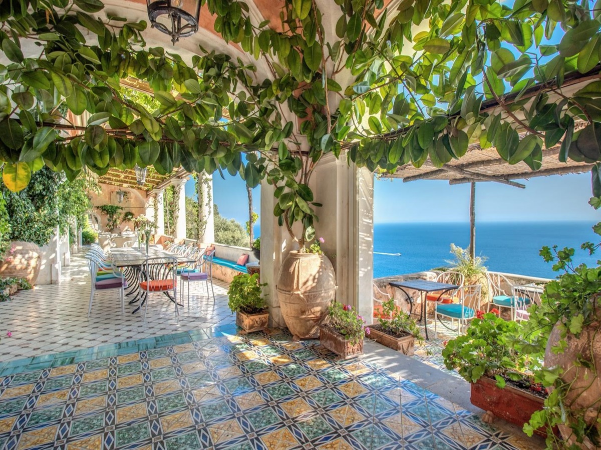 A shaded terrace with colourful blue tiled floor