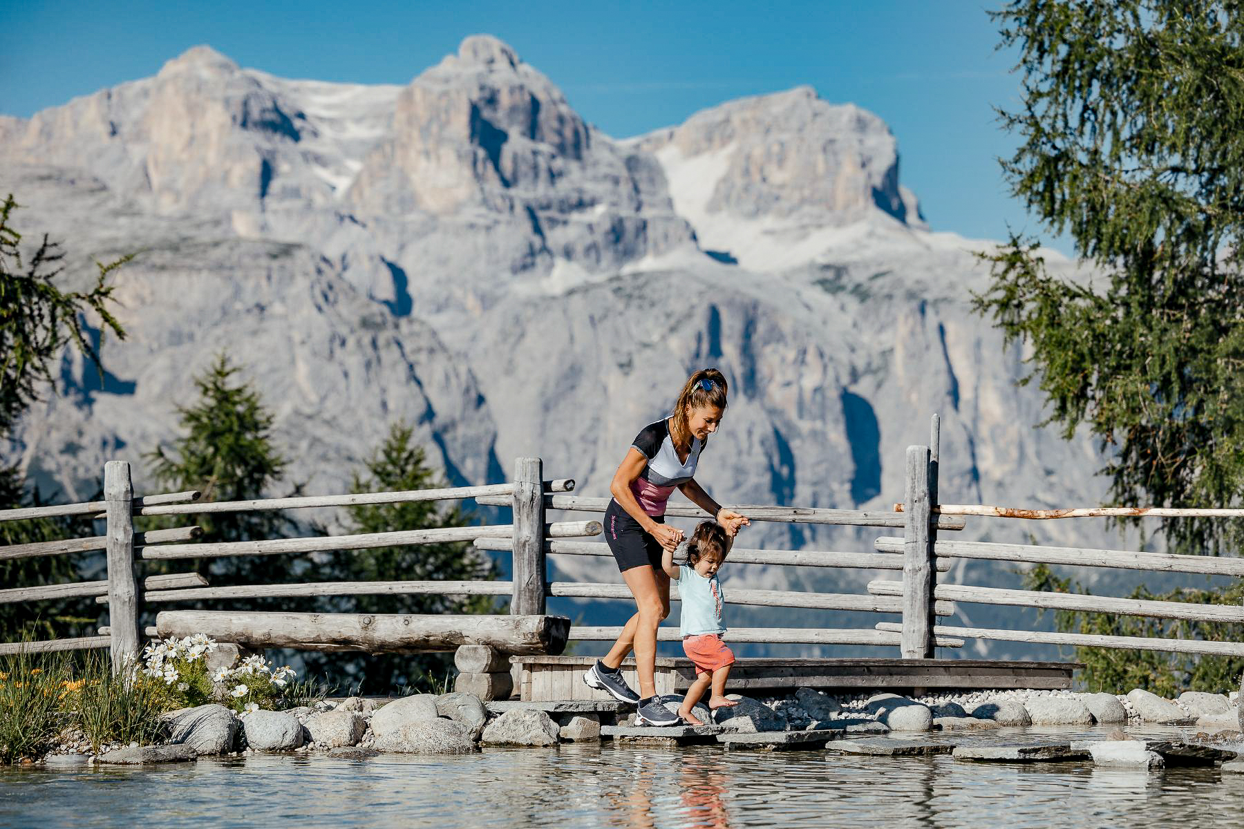 A family crossing a bridge in the Dolomites