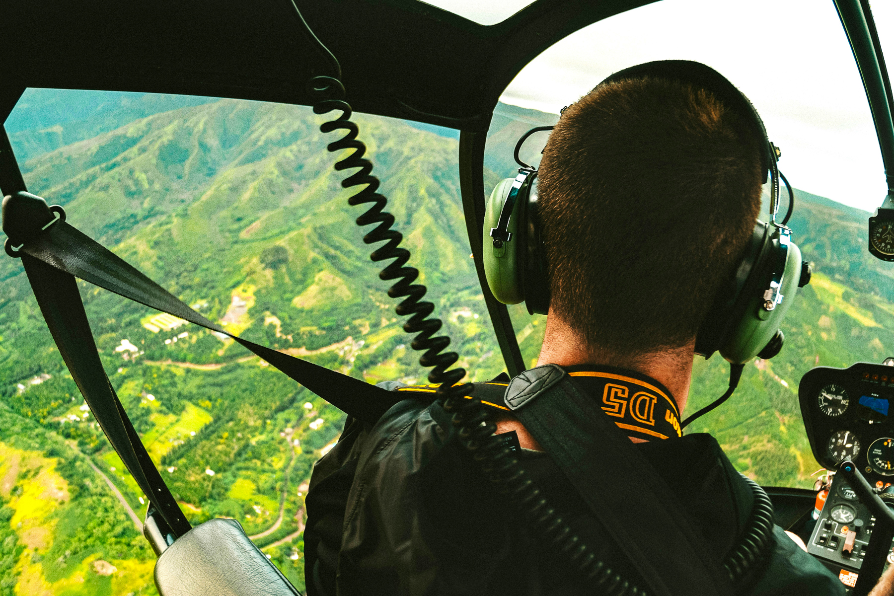 A helicopter pilot flying over the Dolomites