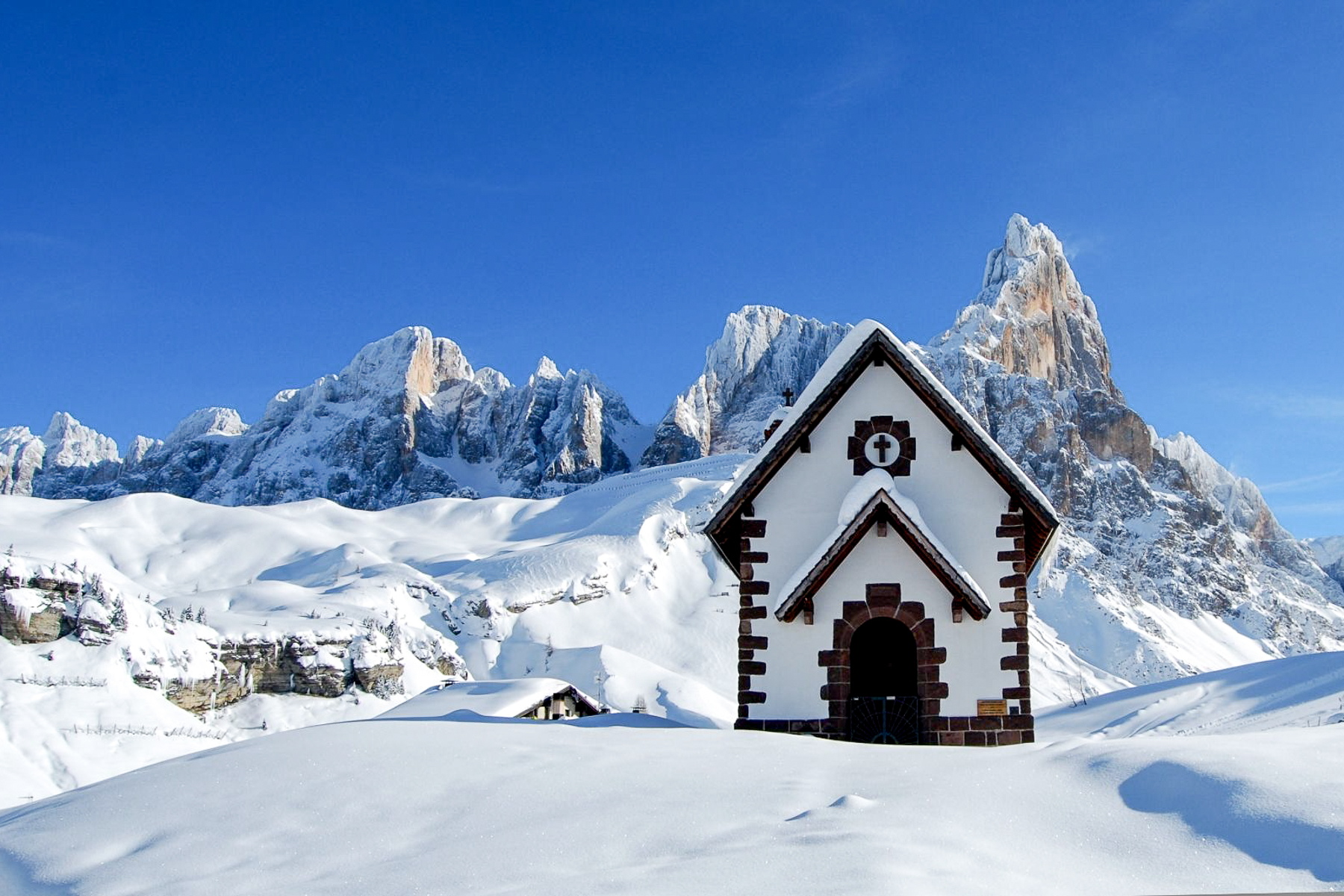 A chapel covered in snow in the Dolomites