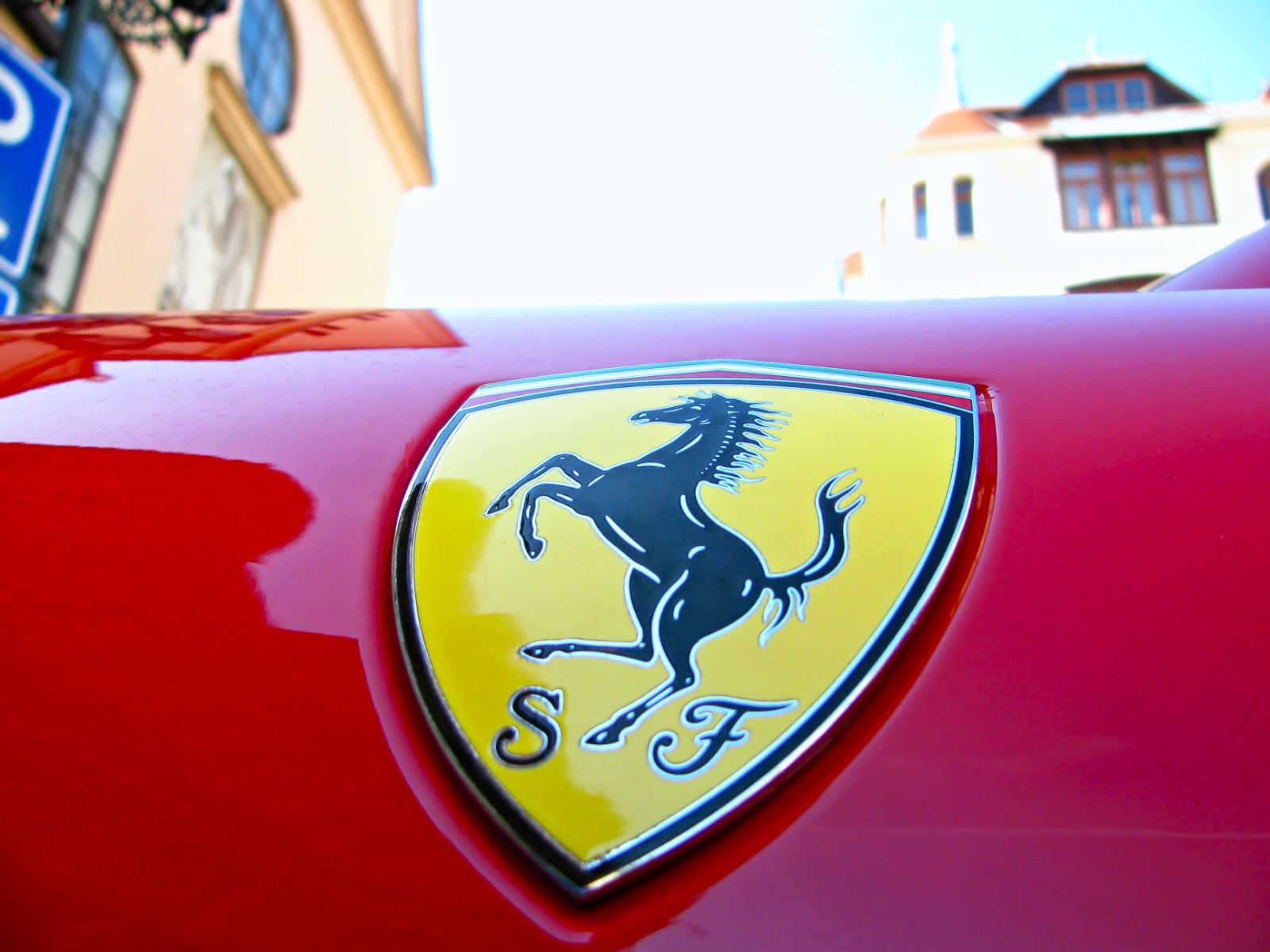 Close up of the Ferrari badge on a red Ferrari in Italy