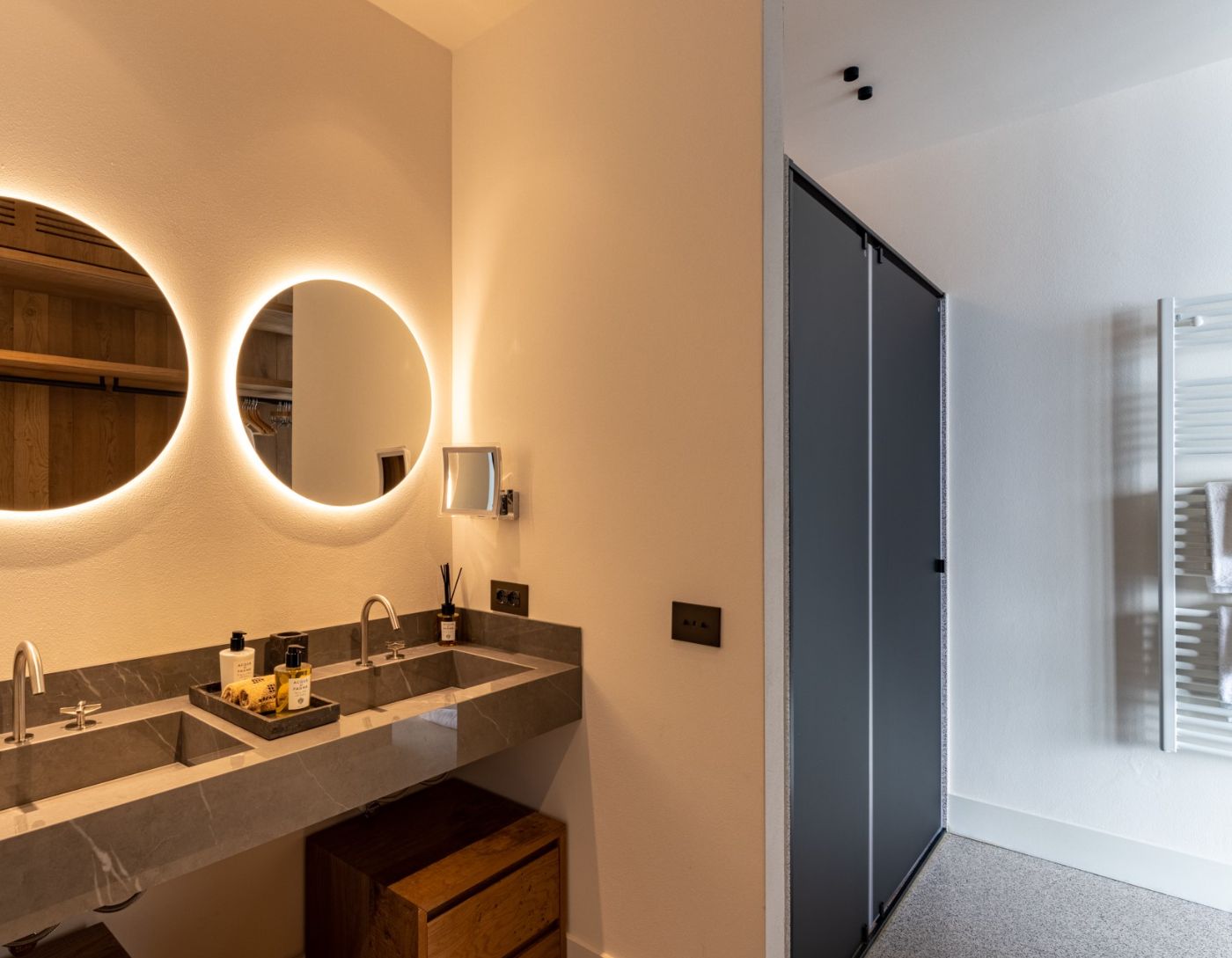 A bathroom with twin basins adn shower unit at private villa Breakwater Bellagio, Lake Como.