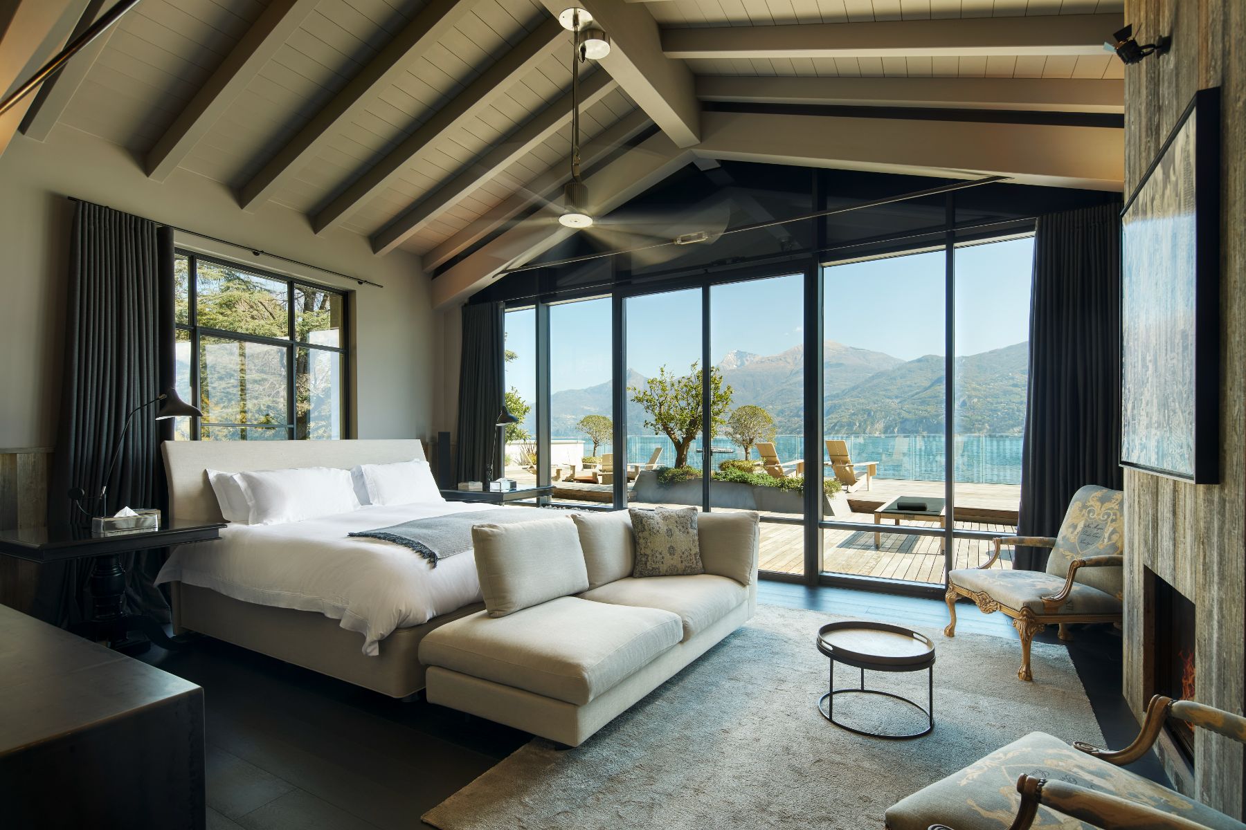 Large bedroom in Breakwater Griante in Lake Como with large french windows opening out to the patio