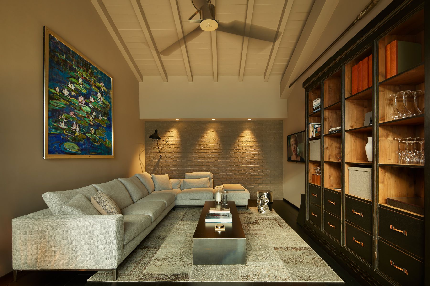 Living room in Breakwater Griante in Lake Como, with a large sofa and art on the wall