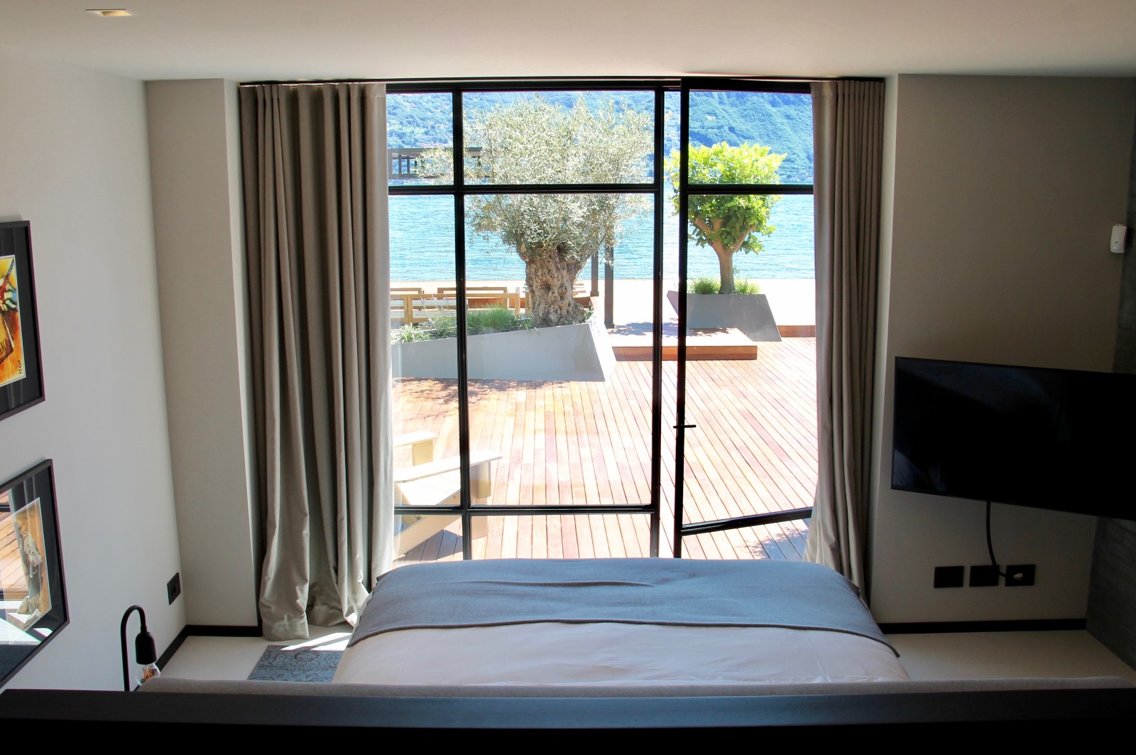 A double bedroom with water access at the Boat House at Lake Como, Italy