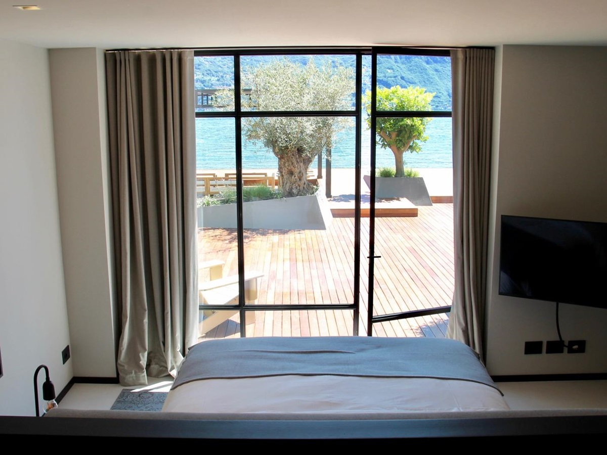 A double bedroom with water access at the Boat House at Lake Como, Italy