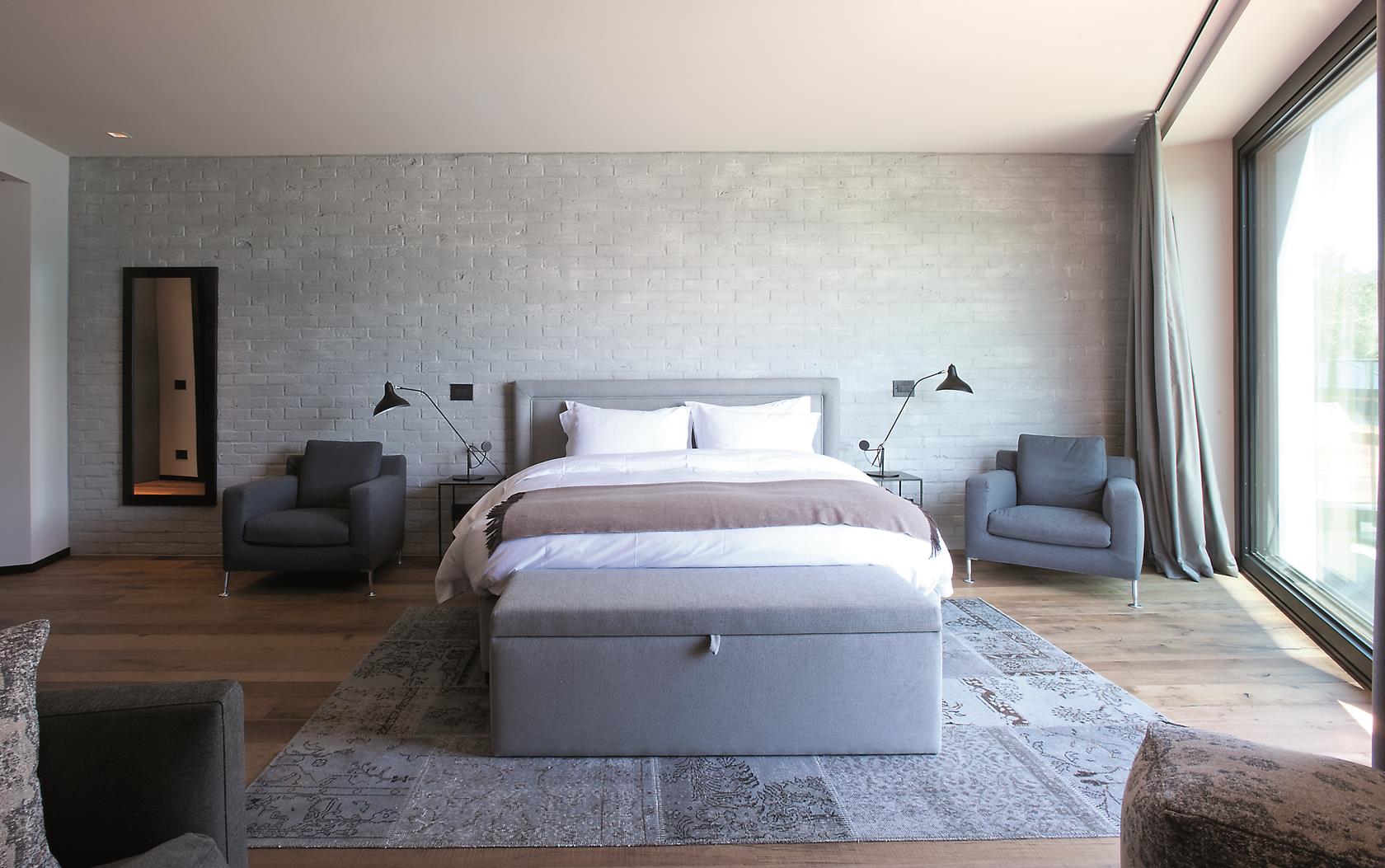 A well-lit double bedroom in the Boat House at Lake Como, Italy