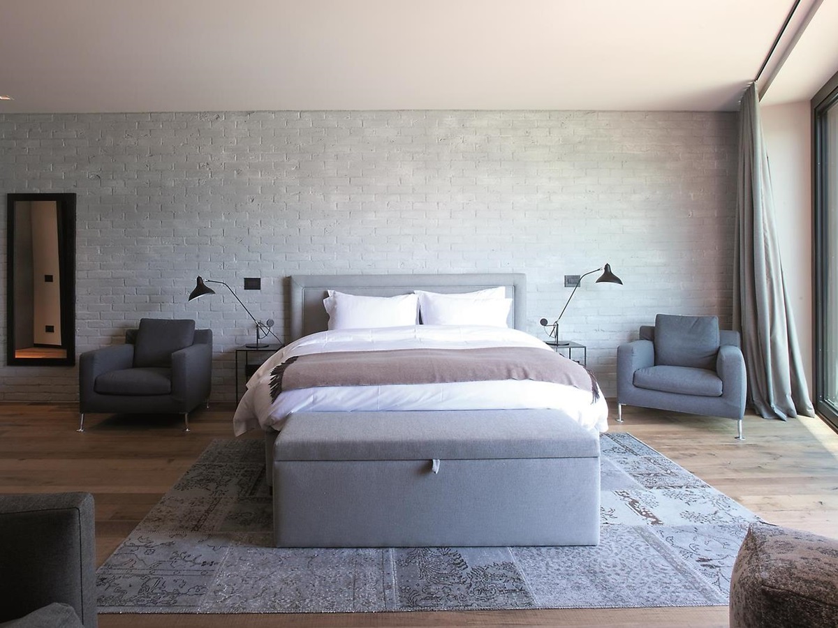 A well-lit double bedroom in the Boat House at Lake Como, Italy
