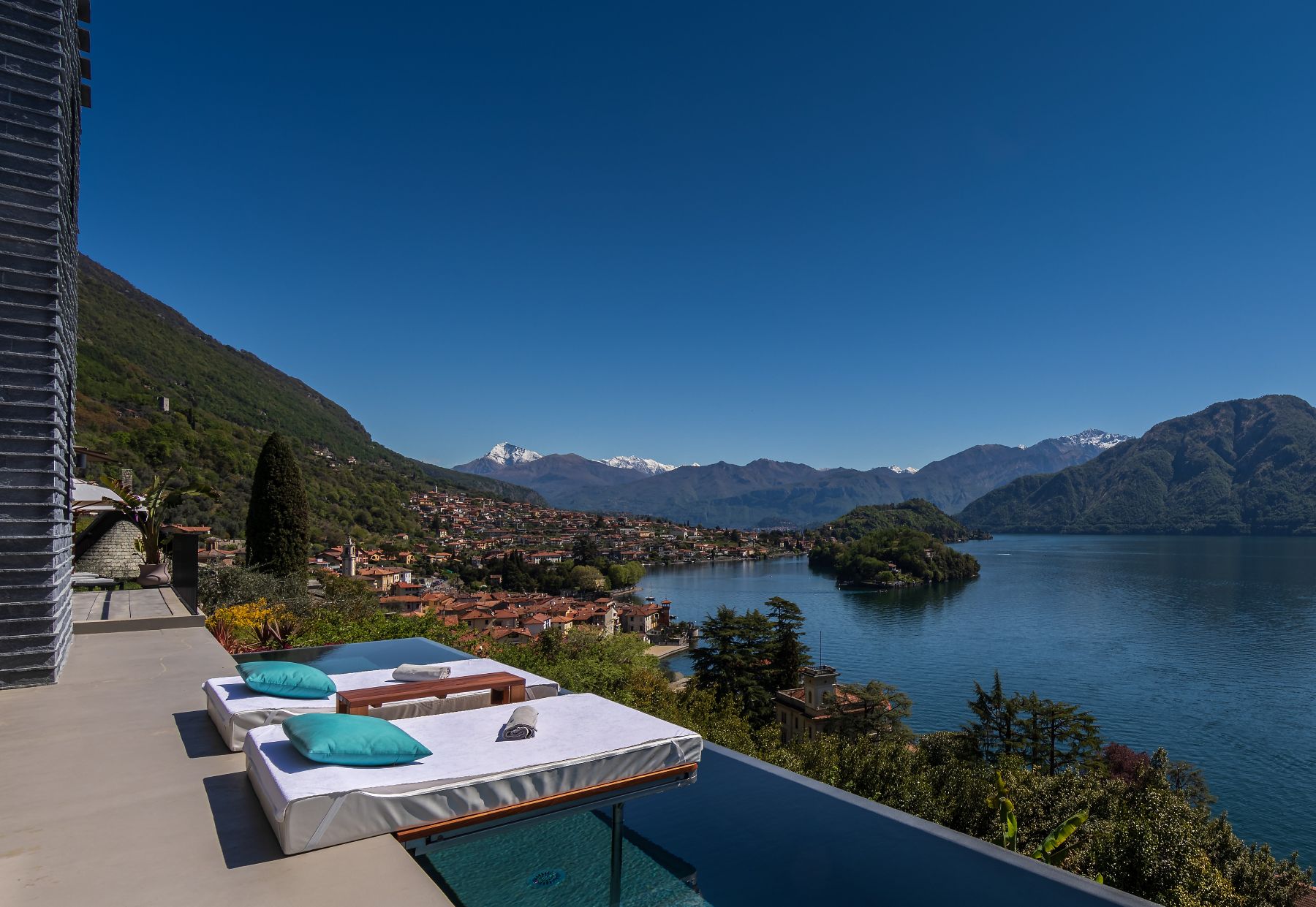 Sun loungers and lake village view at Villa Ardesia in Lake Como