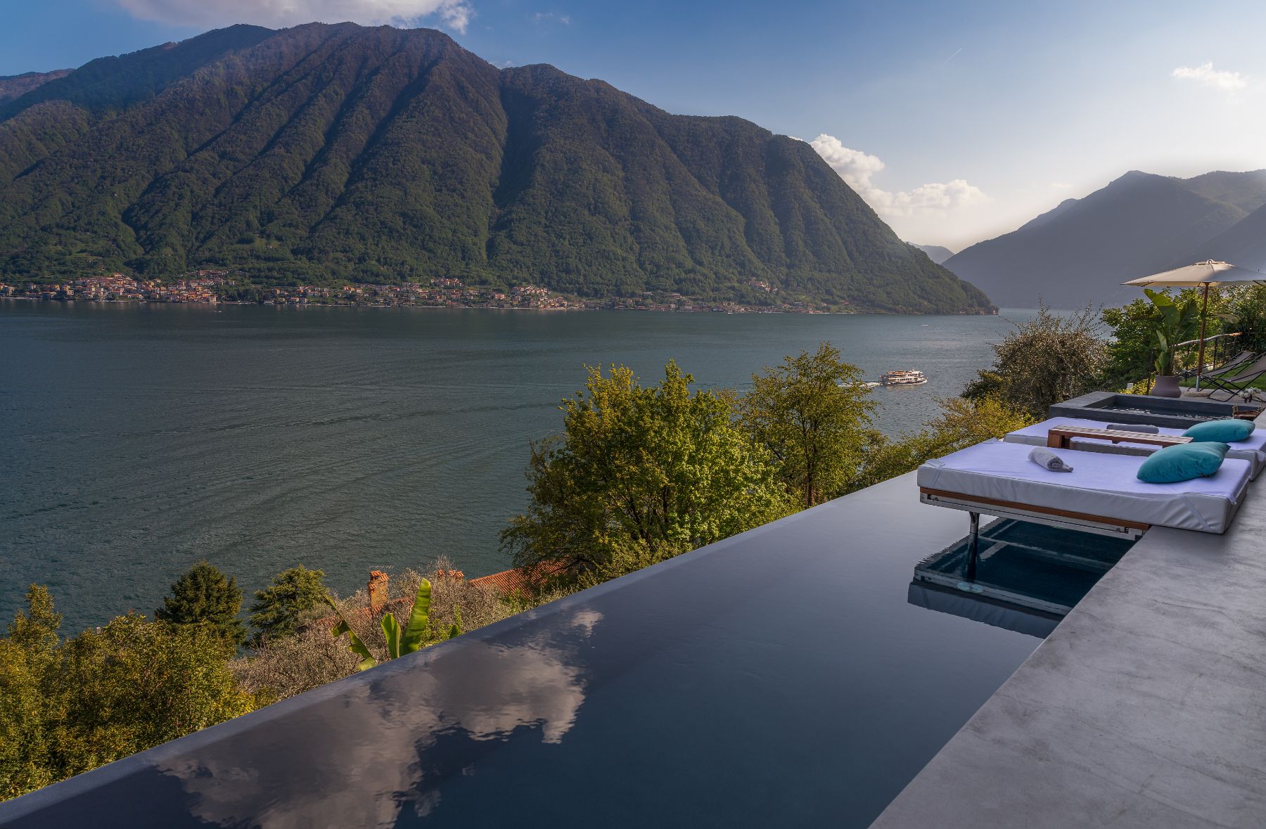Pool sun loungers and mountain view at Villa Ardesia in Lake Como