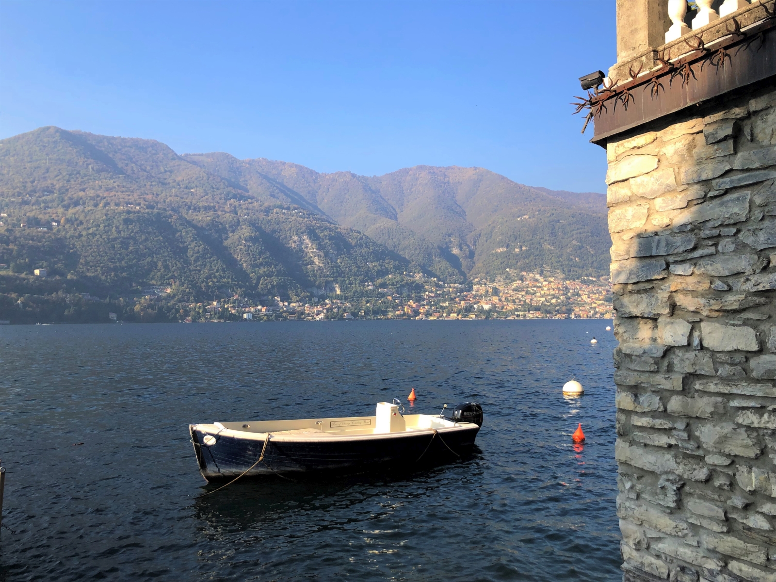 Speed boat and view of Lake Como from Ville del Lago on Lake Como, Italy