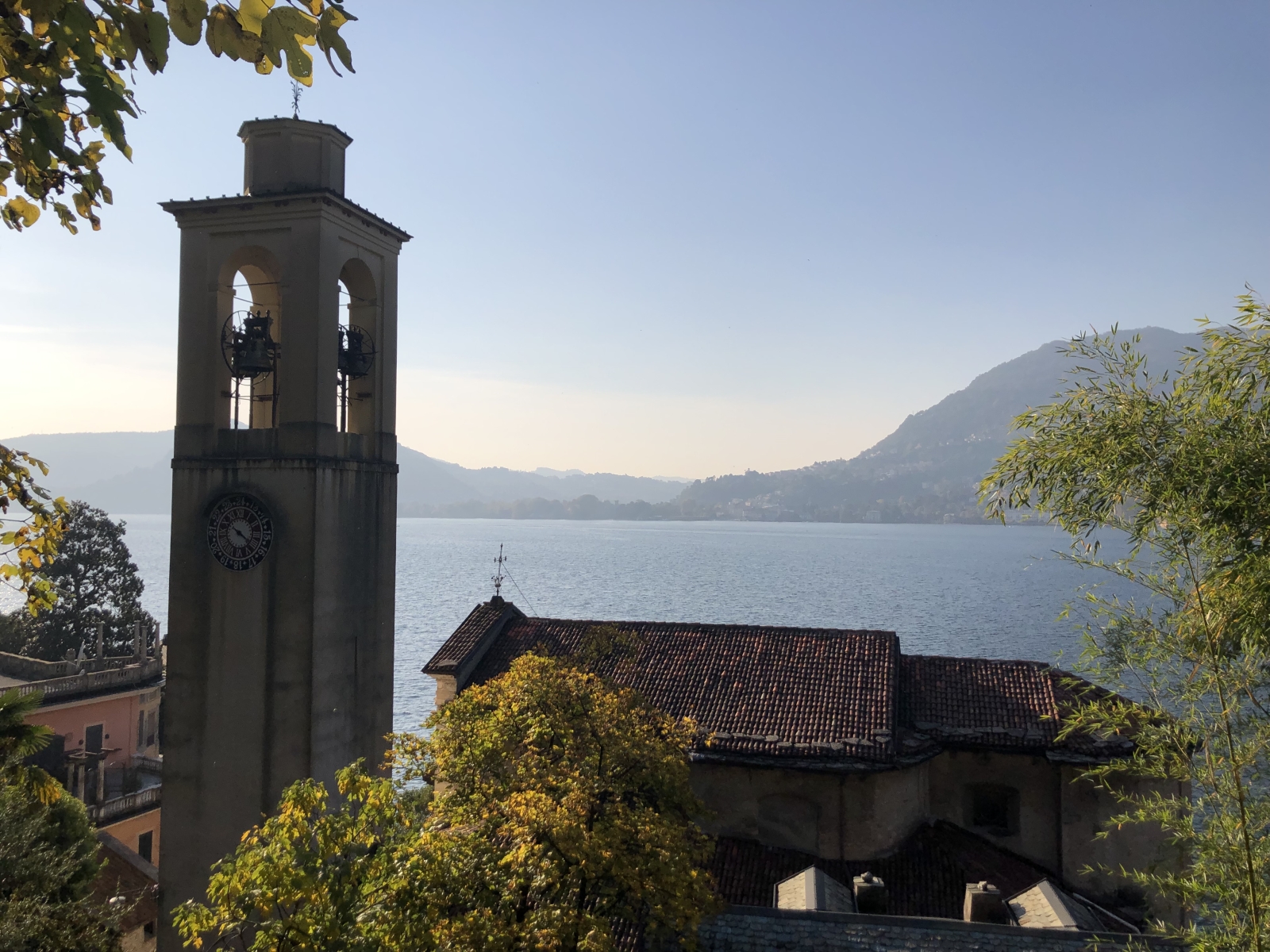 Church and bell tower with view of Lake Como near to Ville del Lago on Lake Como, Italy