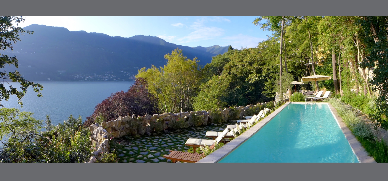 Second pool with lake view and sun loungers at Ville del Lago on Lake Como, Italy
