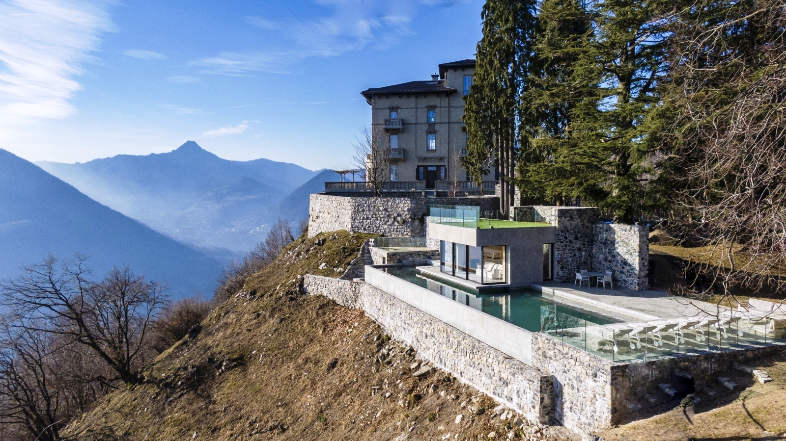 Villa complex with mountains in the background at Villa della Vetta on Lake Como in Italy