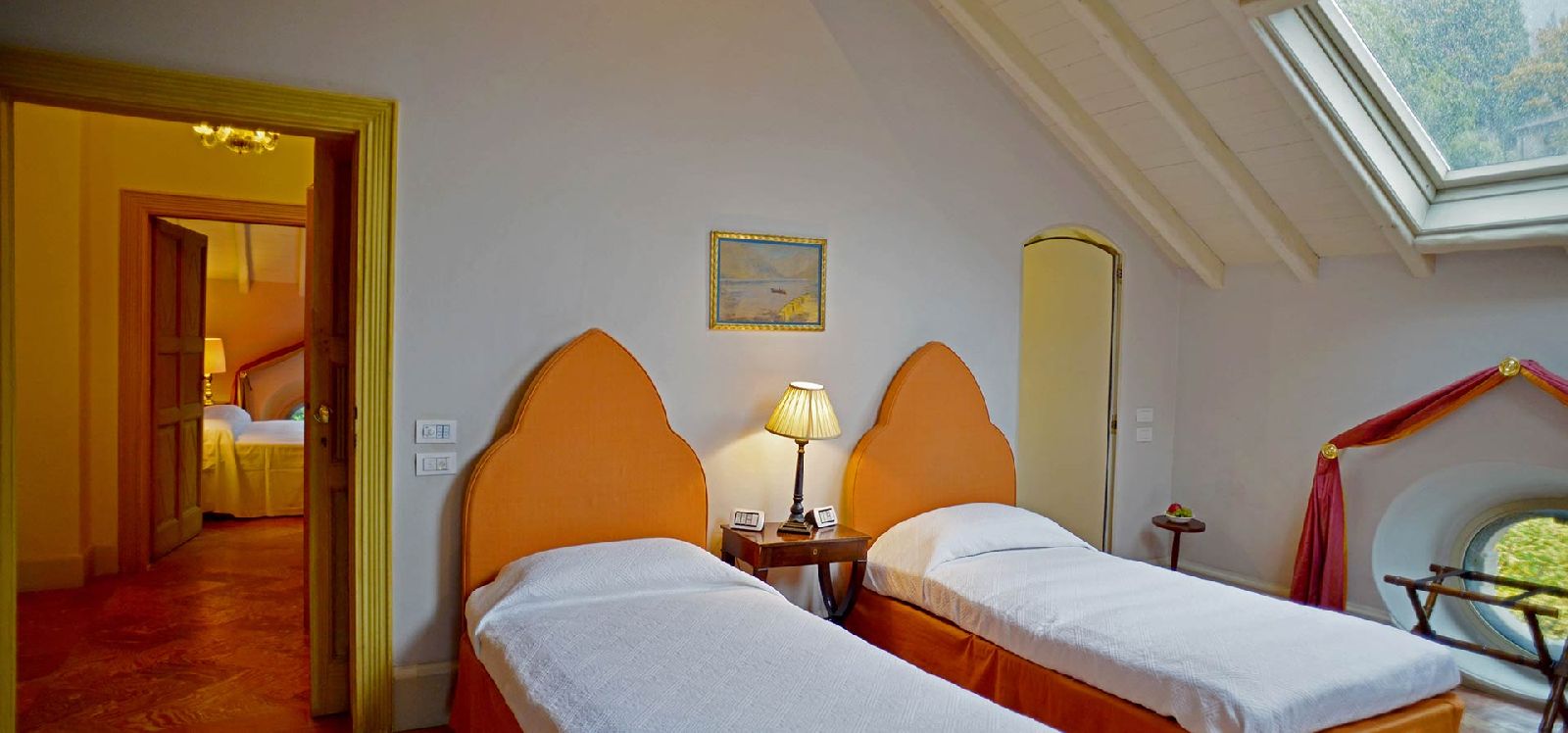 Twin bedroom with wooden headboards at Villa Maria Taglioni on the Italian Lakes