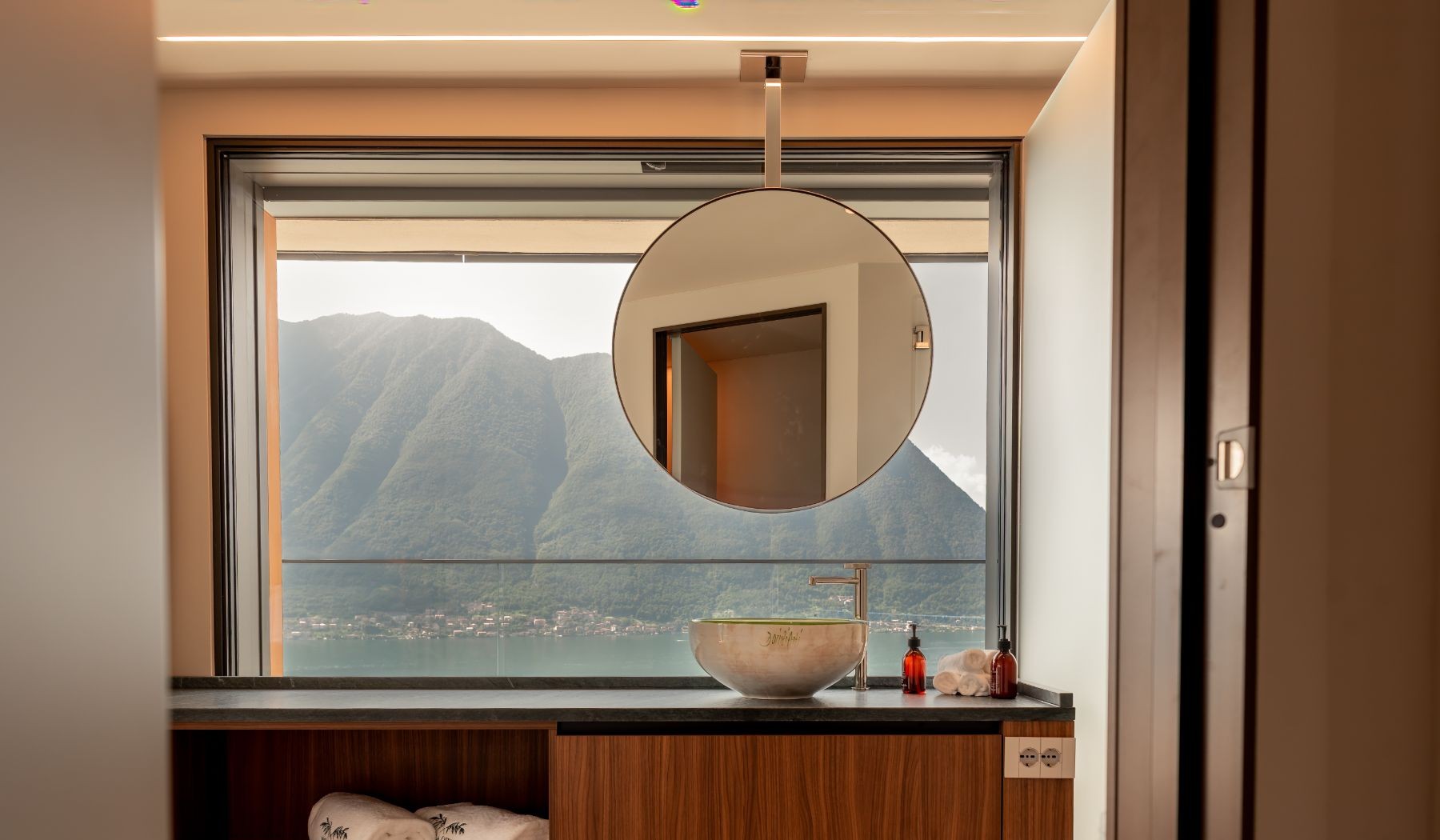 Bathroom mirror and lake view at Villa Orizzonte in Lake Como