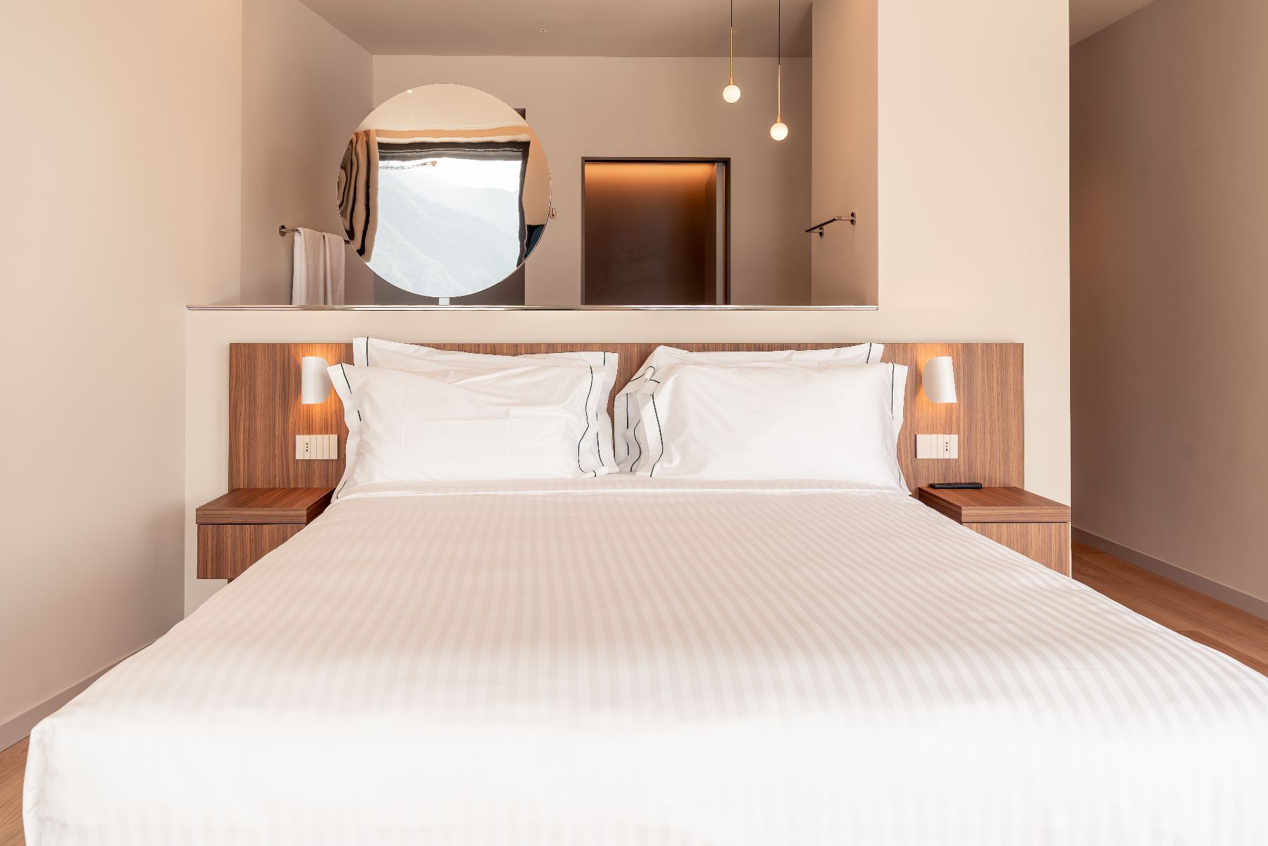 White double bed and mirror at Villa Orizzonte in Lake Como
