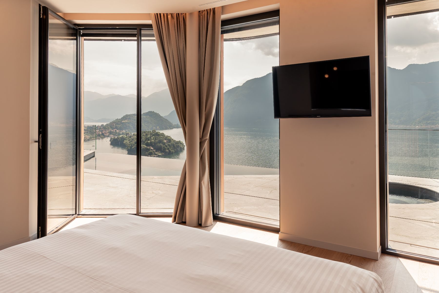 Bedroom TV and lake view at Villa Orizzonte in Lake Como
