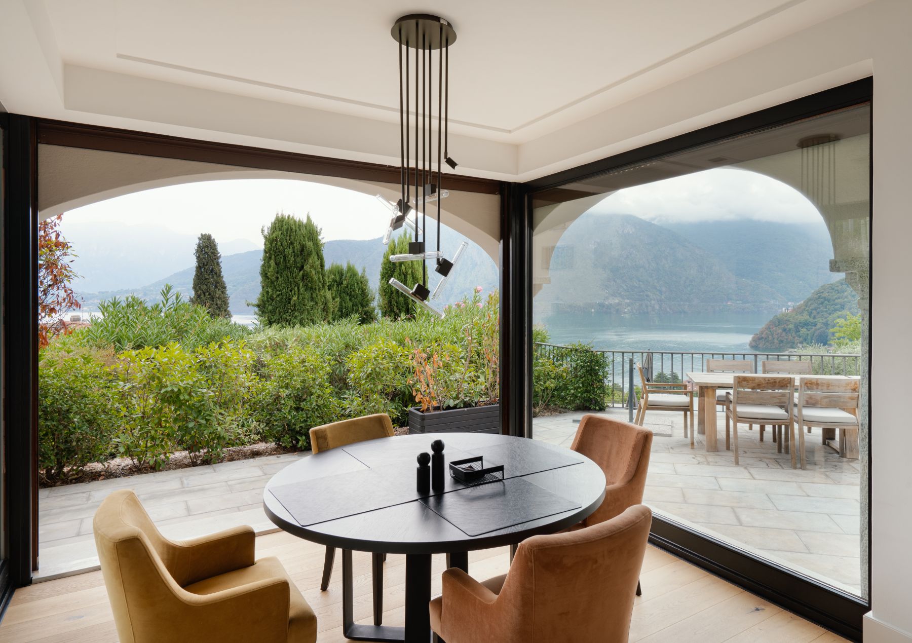 Breakfast table with Lake Como views outside at luxury vacation rental, Villa Pola in the Italian Lakes, Italy