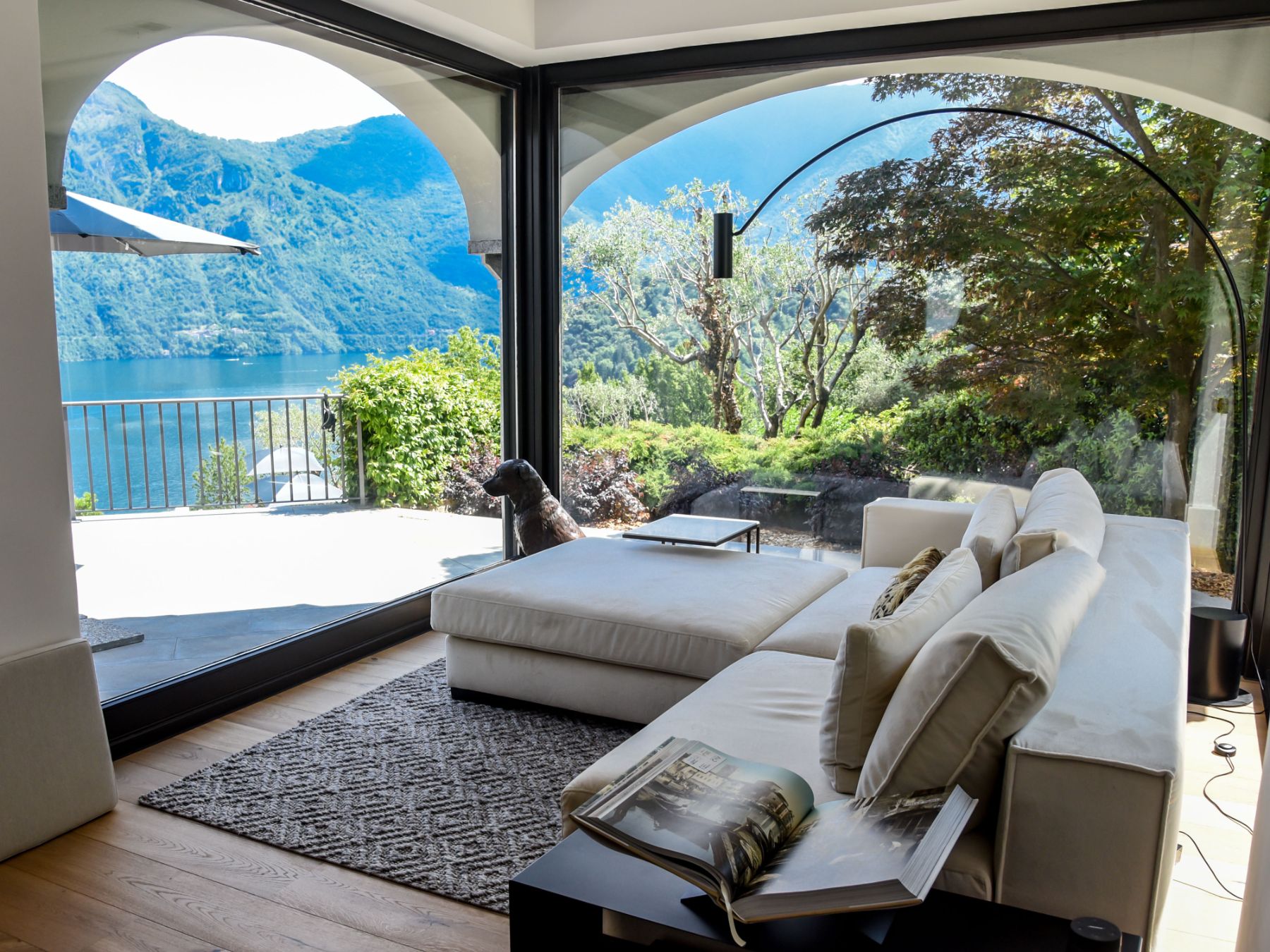 Sitting area with floor to ceiling windows with views over Lake Como at luxury Villa Pola in the Italian Lakes, Italy