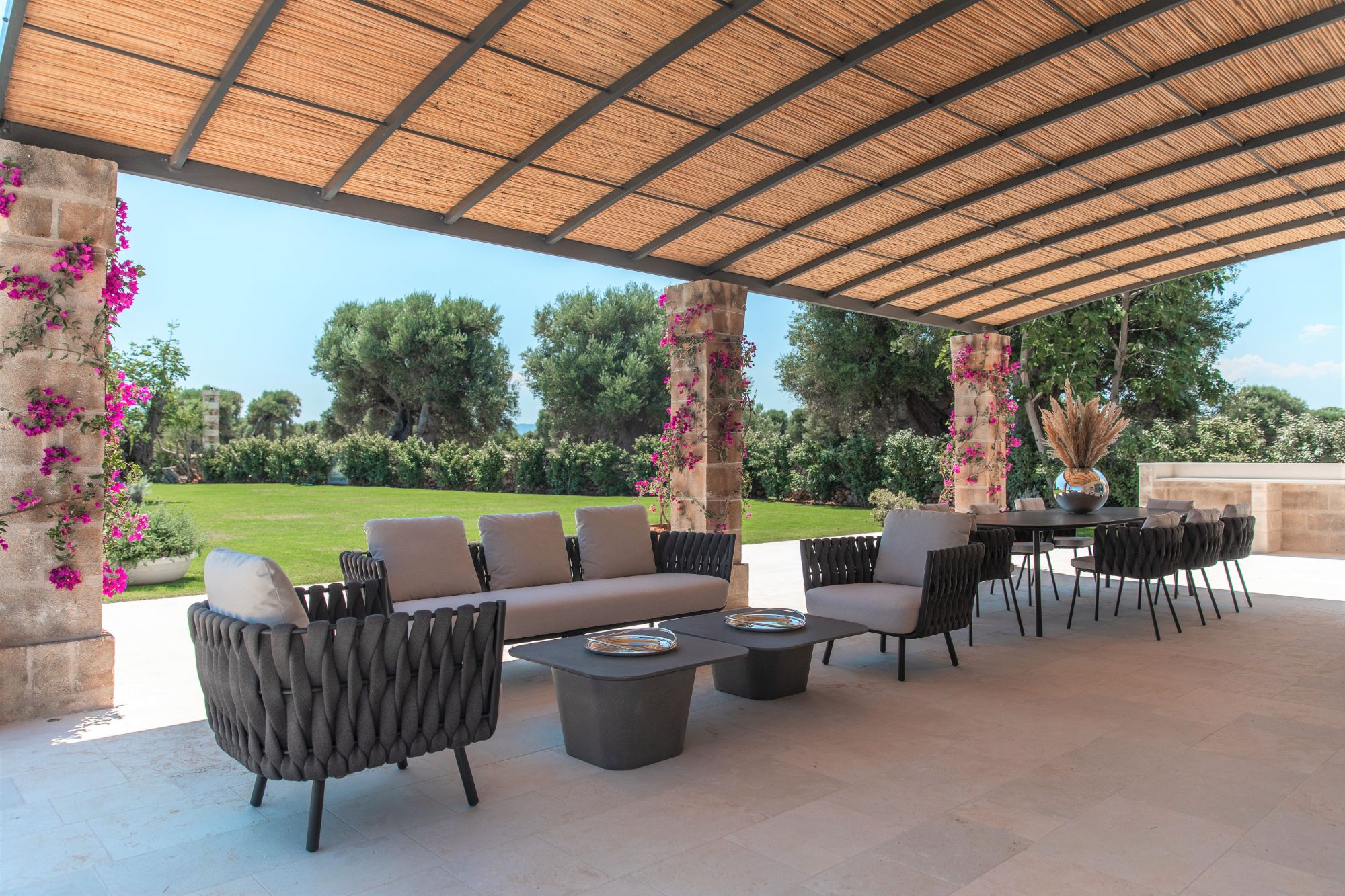 Outdoor terrace with seating and dining area at La Piccola 