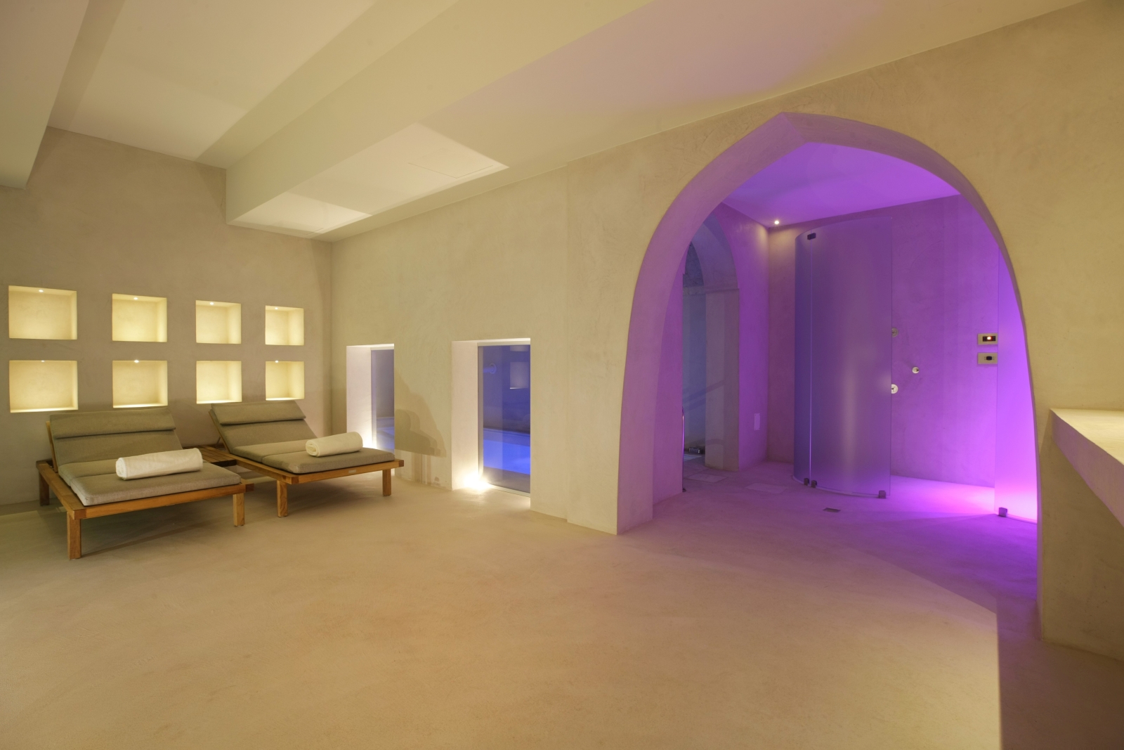 Spa with loungers, shower and indoor swimming pool at Masseria dei Papi in Puglia, Italy