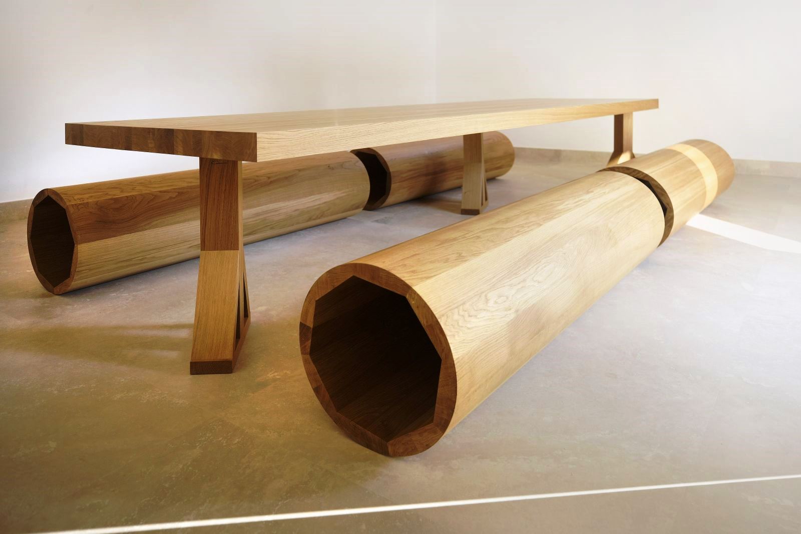 Designer wooden dining table and four circular wooden seats at villa masseria dei papi in Puglian, Italy