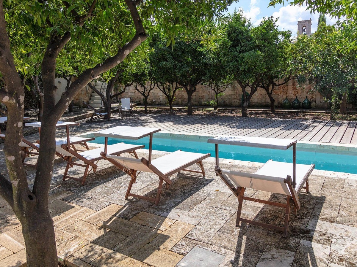 Pool area with loungers at Palazzo del Duca