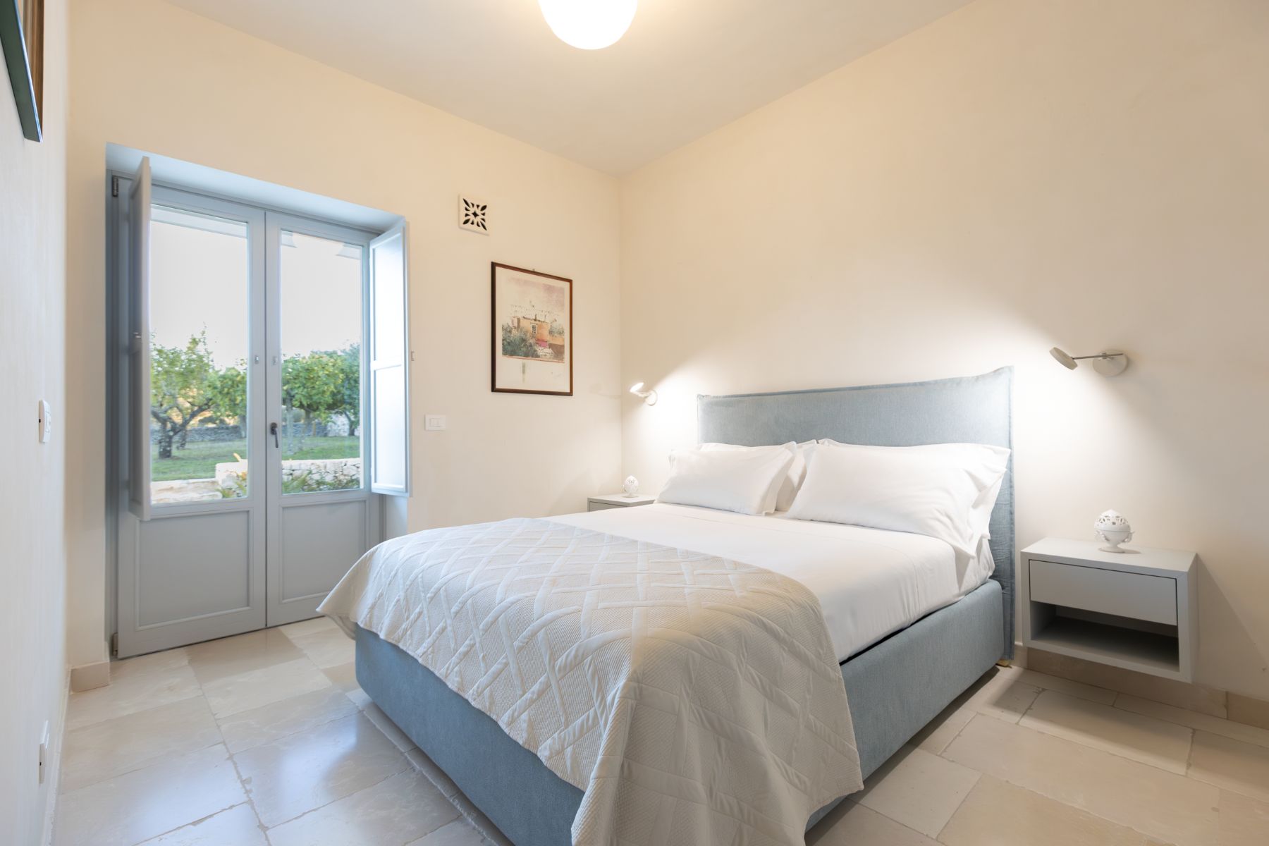 Double bedroom with garden access at Trulli Armonia in Puglia