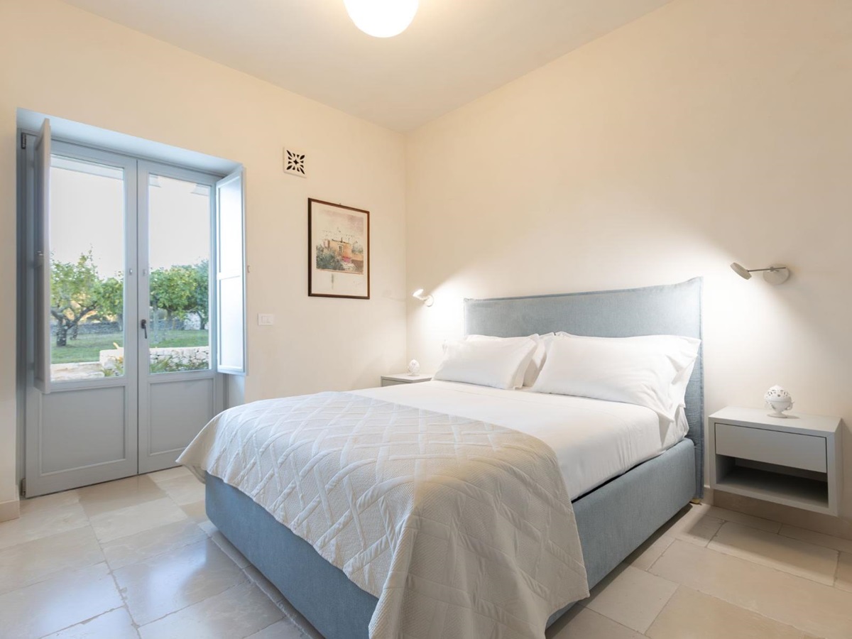 Double bedroom with garden access at Trulli Armonia in Puglia