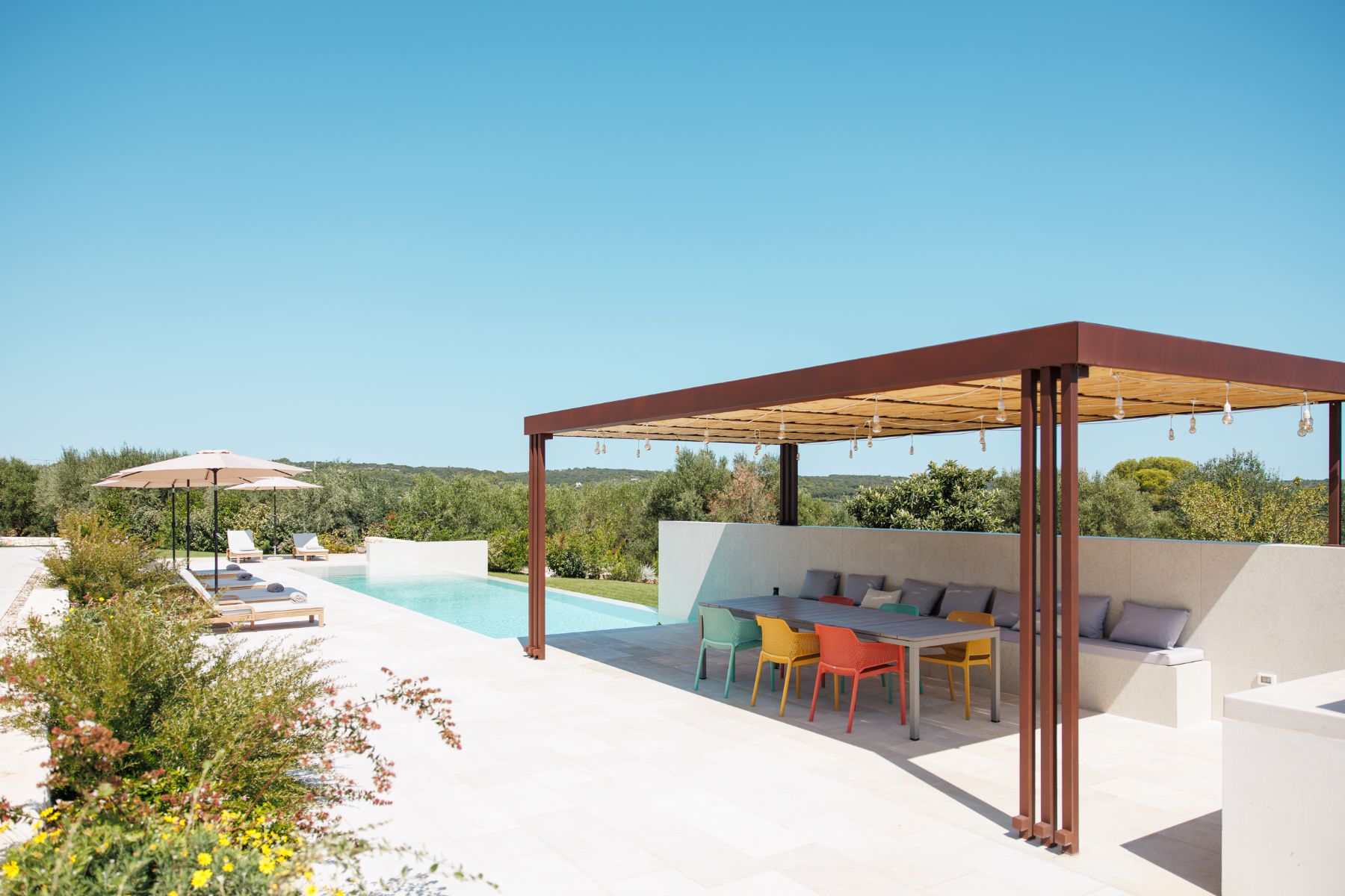 Outdoor pool seating area at Trulli Armonia in Puglia