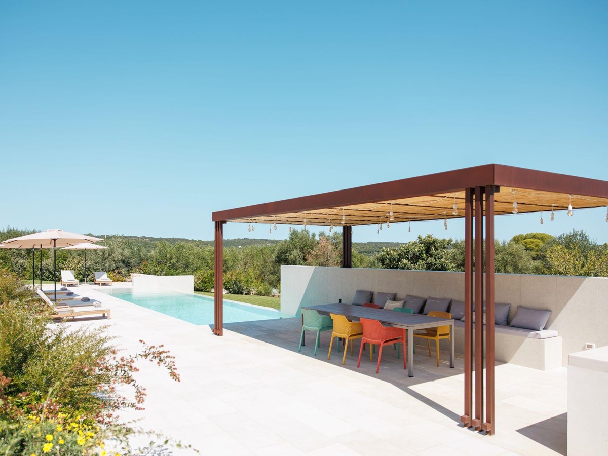 Outdoor pool seating area at Trulli Armonia in Puglia