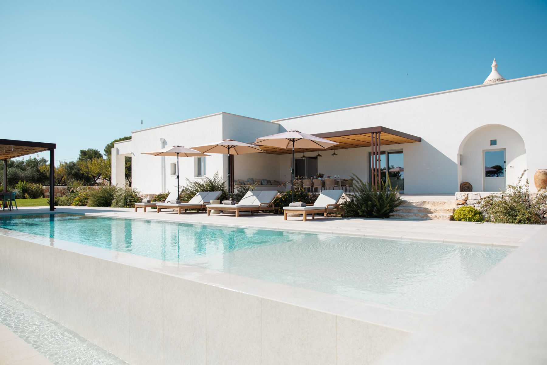 Low angle of pool and villa at Trulli Armonia in Puglia