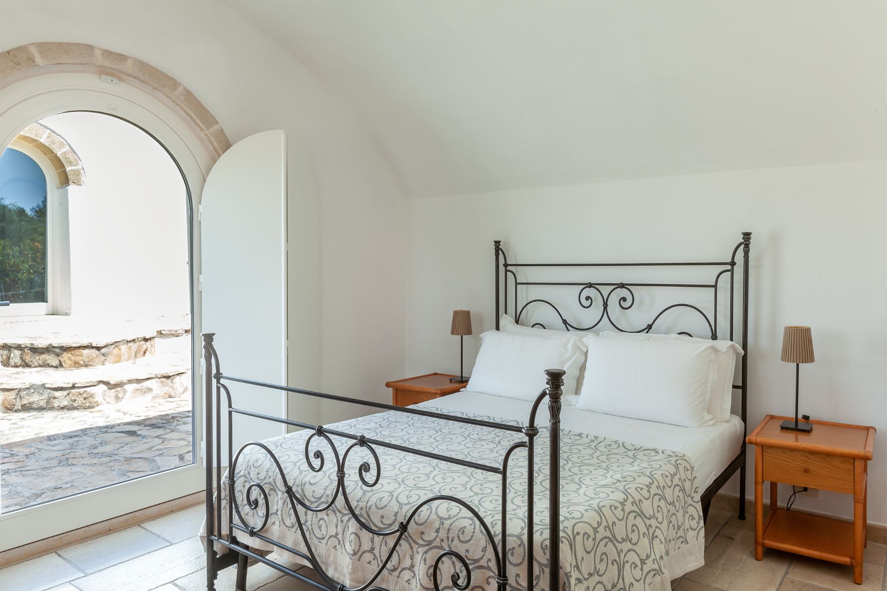 Double bed with window view at Trulli Lucia in Puglia