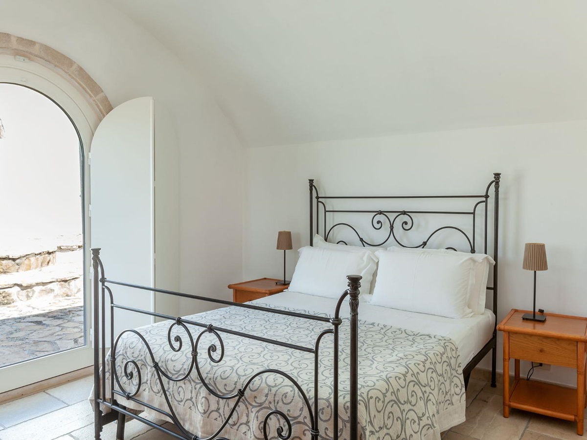 Double bed with window view at Trulli Lucia in Puglia