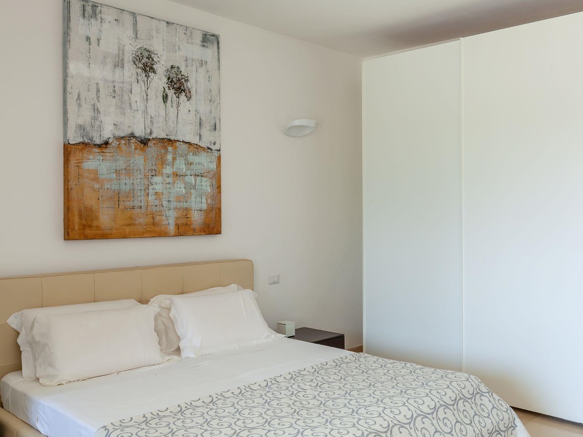Double bed with grey cover at Trulli Lucia in Puglia