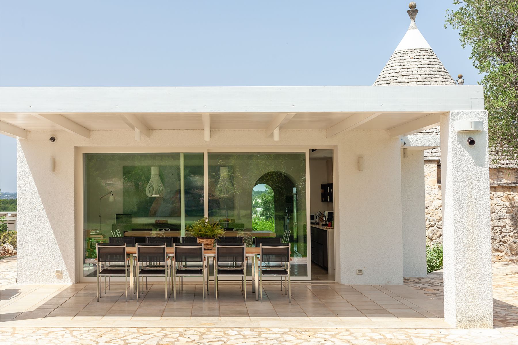 Full view of kitchen doors and outdoor table at Trulli Lucia in Puglia